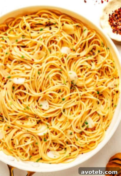 Spaghetti Aglio e Olio with fresh parsley and cheese.