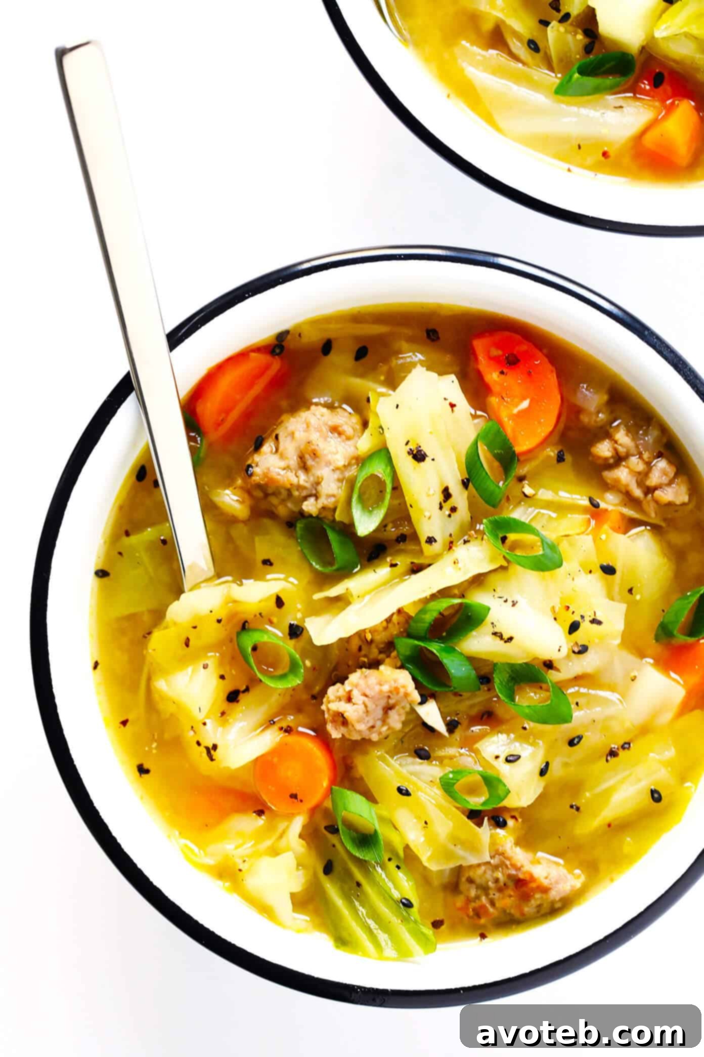 This Egg Roll Soup recipe is SO tasty!! It's basically an Asian cabbage soup, simmered with zesty sausage, carrots, sesame and ginger, and topped with crispy wonton strips if desired. It's the perfect easy dinner recipe. | Gimme Some Oven #glutenfree #soup #recipe #gf