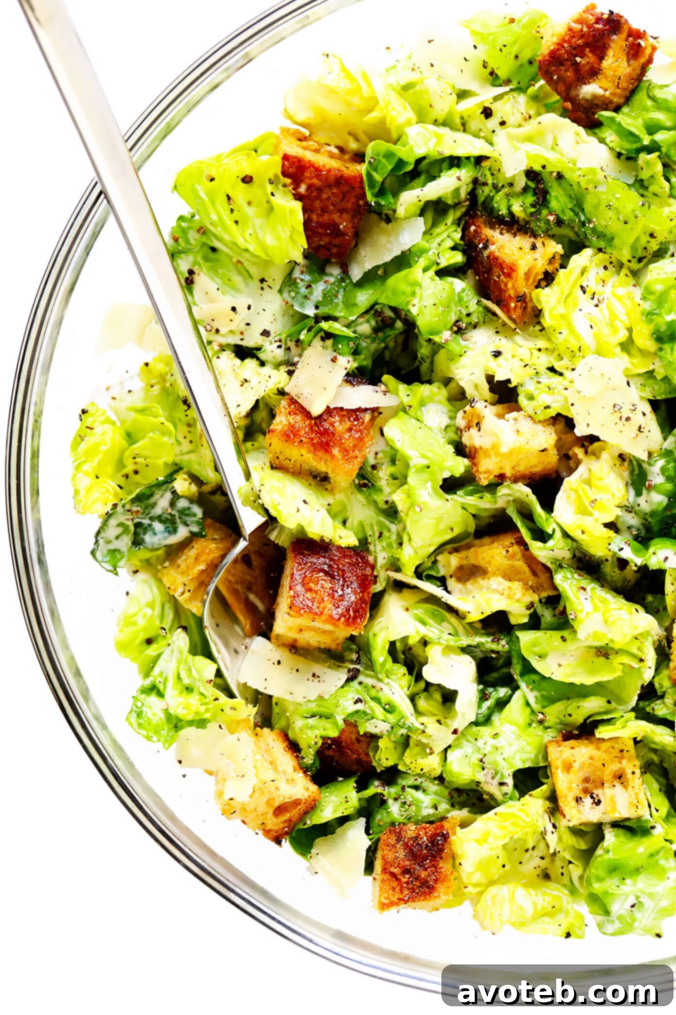 A bowl of the BEST homemade Caesar Salad, with golden sourdough croutons and freshly shaved Parmesan. Perfect as a side or main dish. | gimmesomeoven.com #caesar #salad #dressing #homemade #glutenfree #healthy #summer #italian Delicious Caesar Salad in a bowl, featuring homemade croutons and rich Parmesan cheese.