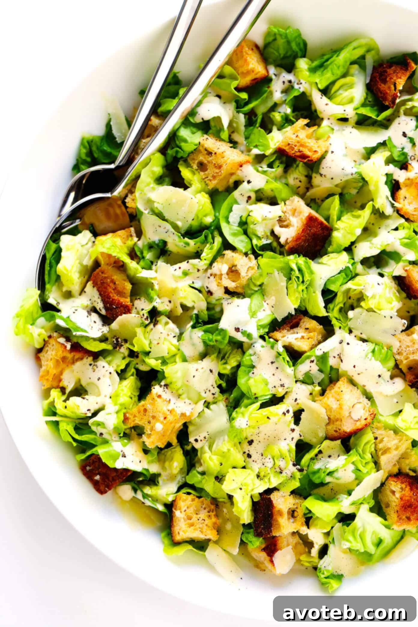The BEST homemade Caesar Salad, perfectly drizzled with creamy Caesar dressing, ready for its final toss and serving. | gimmesomeoven.com #caesar #salad #dressing #homemade #glutenfree #healthy #summer #italian Caesar Salad with Homemade Dressing Drizzled on Top, ready to be tossed.