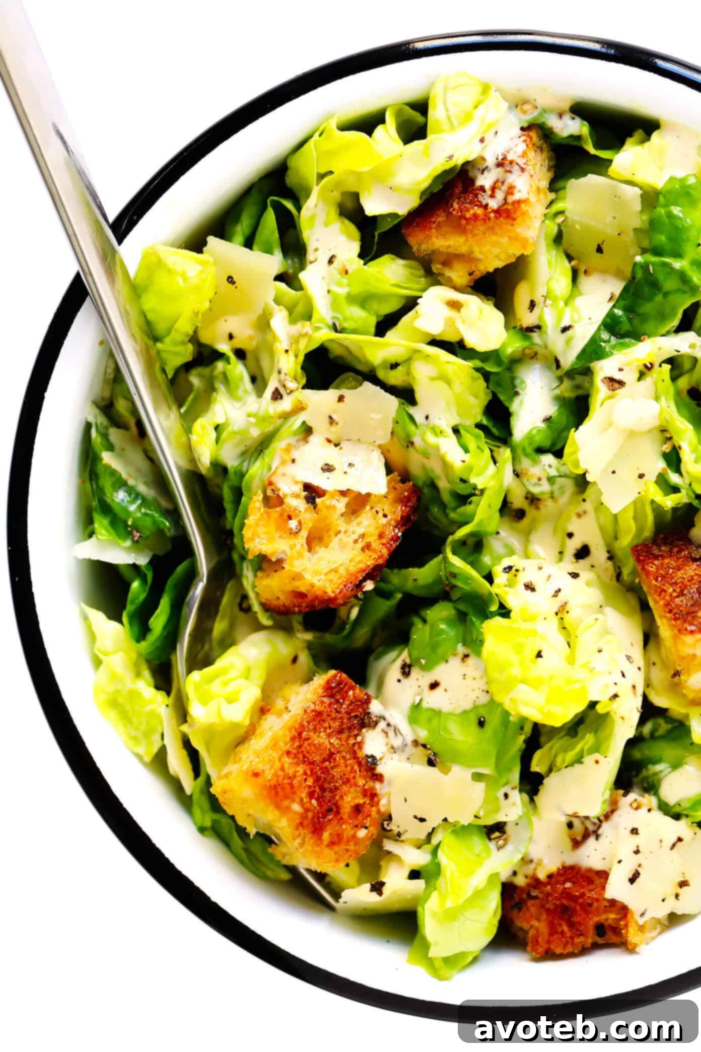 The ultimate homemade Caesar Salad, presented in a bowl with golden croutons and ample Parmesan, ready to be savored. | gimmesomeoven.com #caesar #salad #dressing #homemade #glutenfree #healthy #summer #italian Classic Caesar Salad in a bowl, generously topped with homemade croutons and Parmesan cheese.
