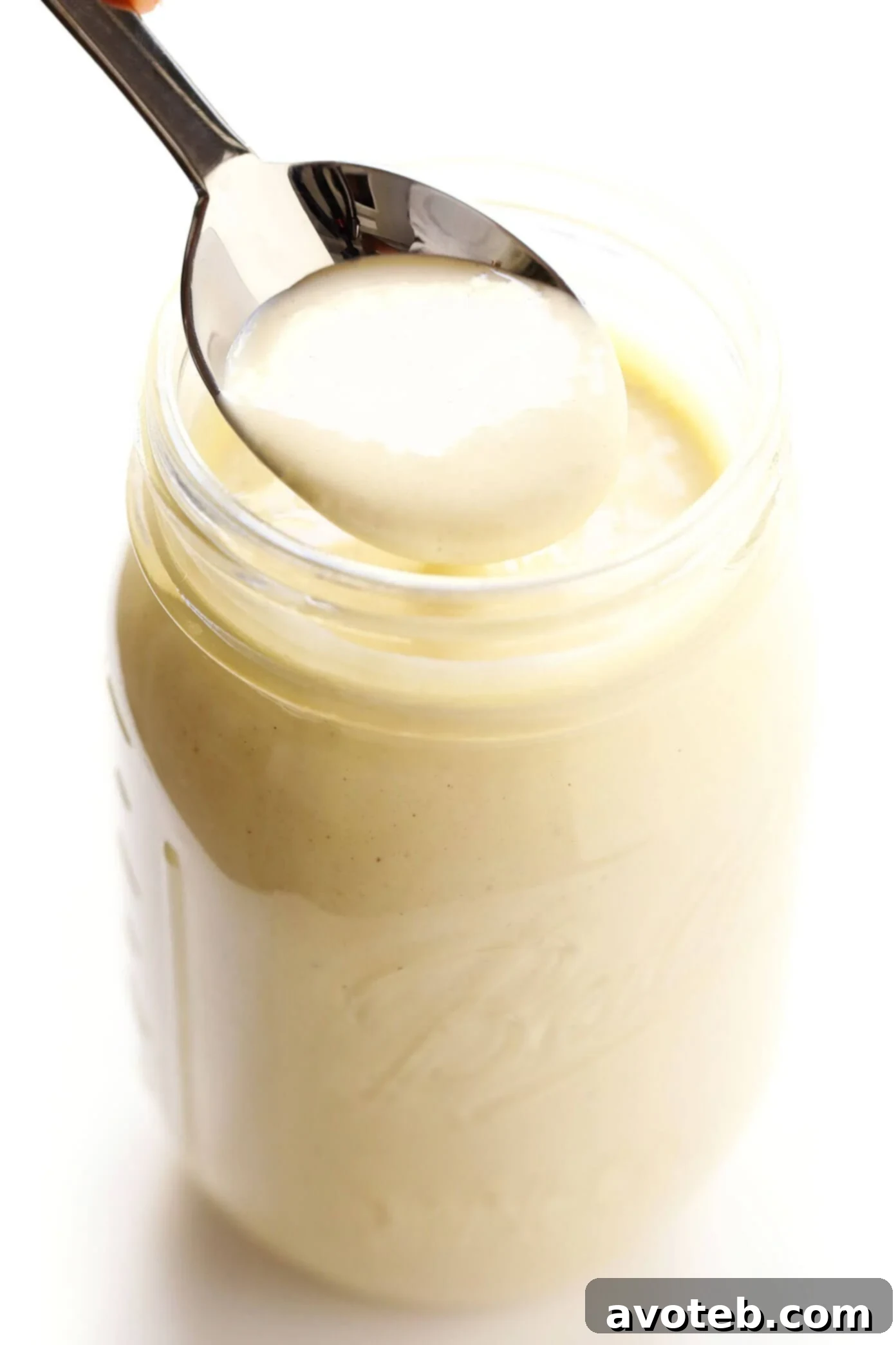 Creamy Homemade Caesar Dressing in a bowl with fresh ingredients