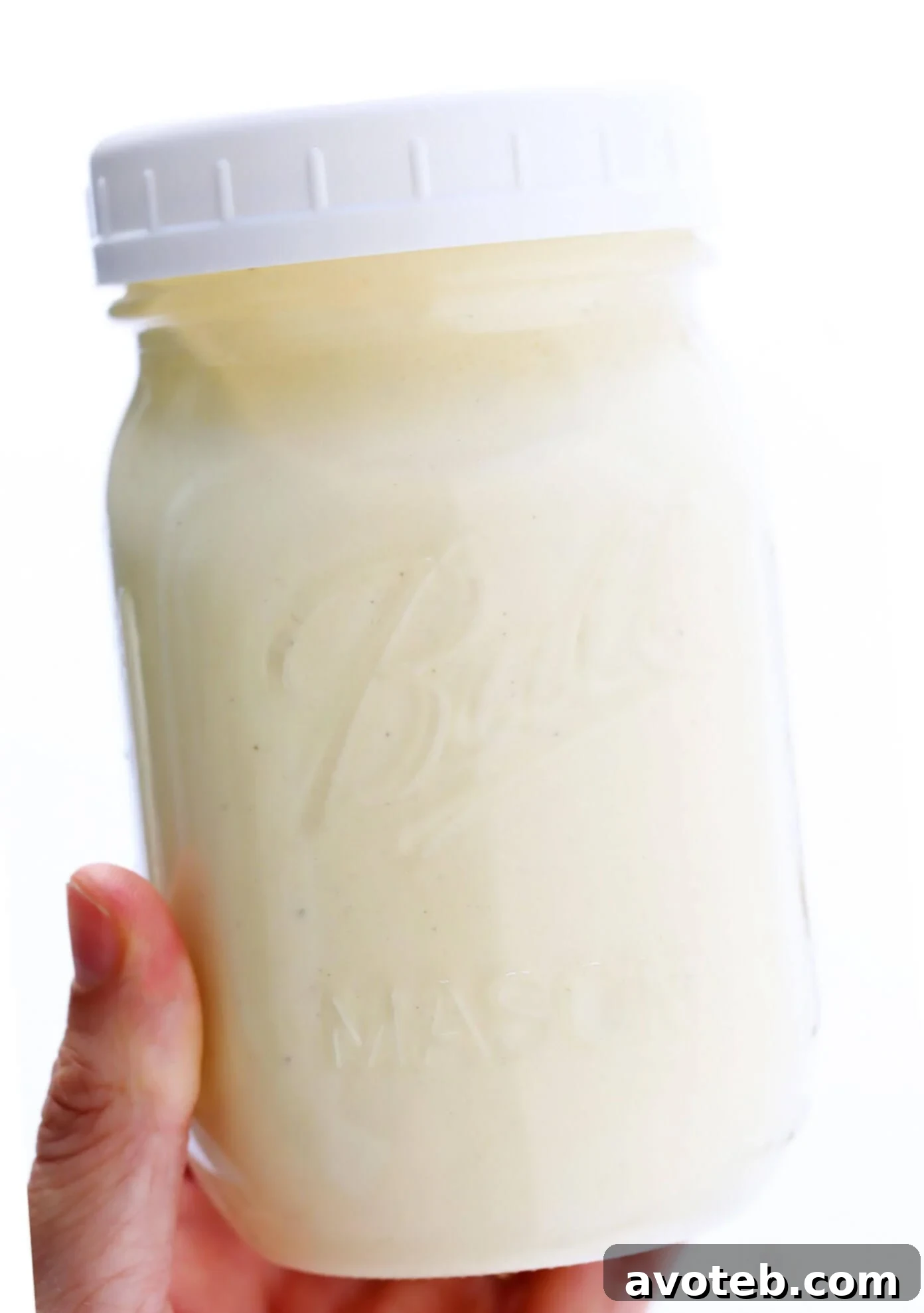 Jar of Homemade Caesar Dressing on a rustic wooden table