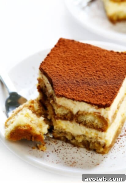 Delicious classic tiramisu with coffee-soaked ladyfingers and creamy mascarpone filling, dusted with cocoa powder