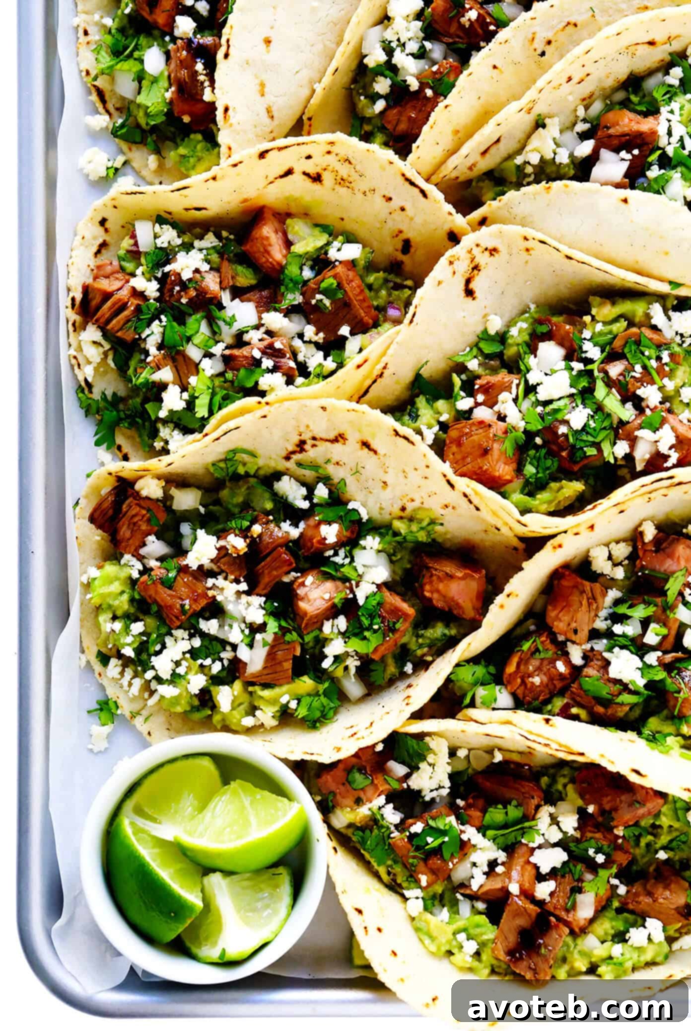 Tray of Carne Asada Tacos with Lime, Guacamole and Queso Fresco