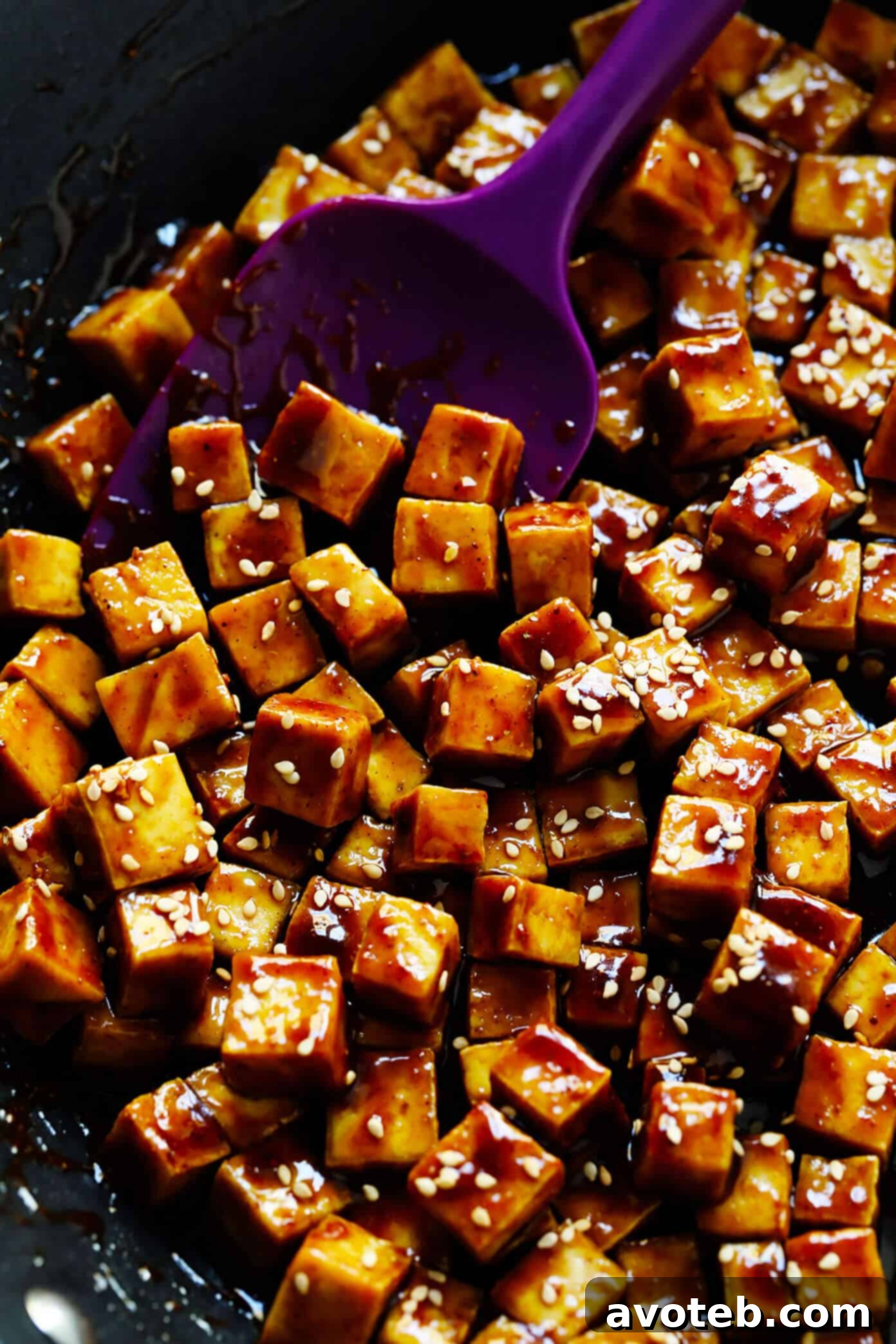 Crispy Tofu being sautéed in a pan, coated with a delicious Five Spice Hoisin Sauce.