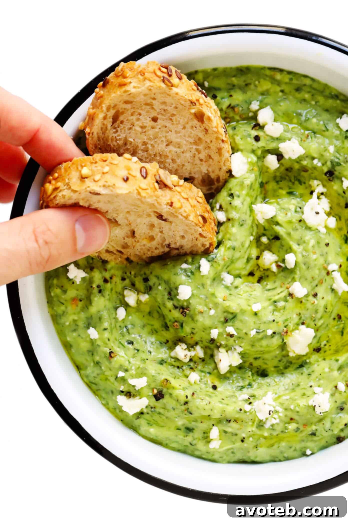 Green Goddess Feta Dip served elegantly with a variety of dippers including rustic bread slices, crisp cucumber, and colorful bell pepper strips.