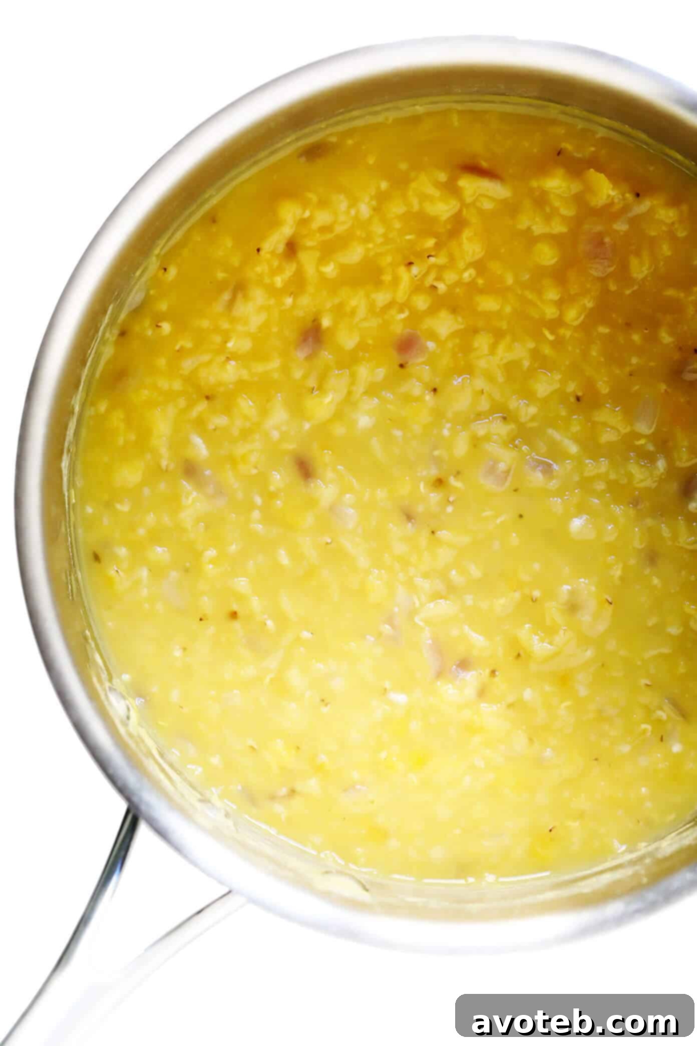 Yellow split peas simmering in a pot for Greek Fava preparation.