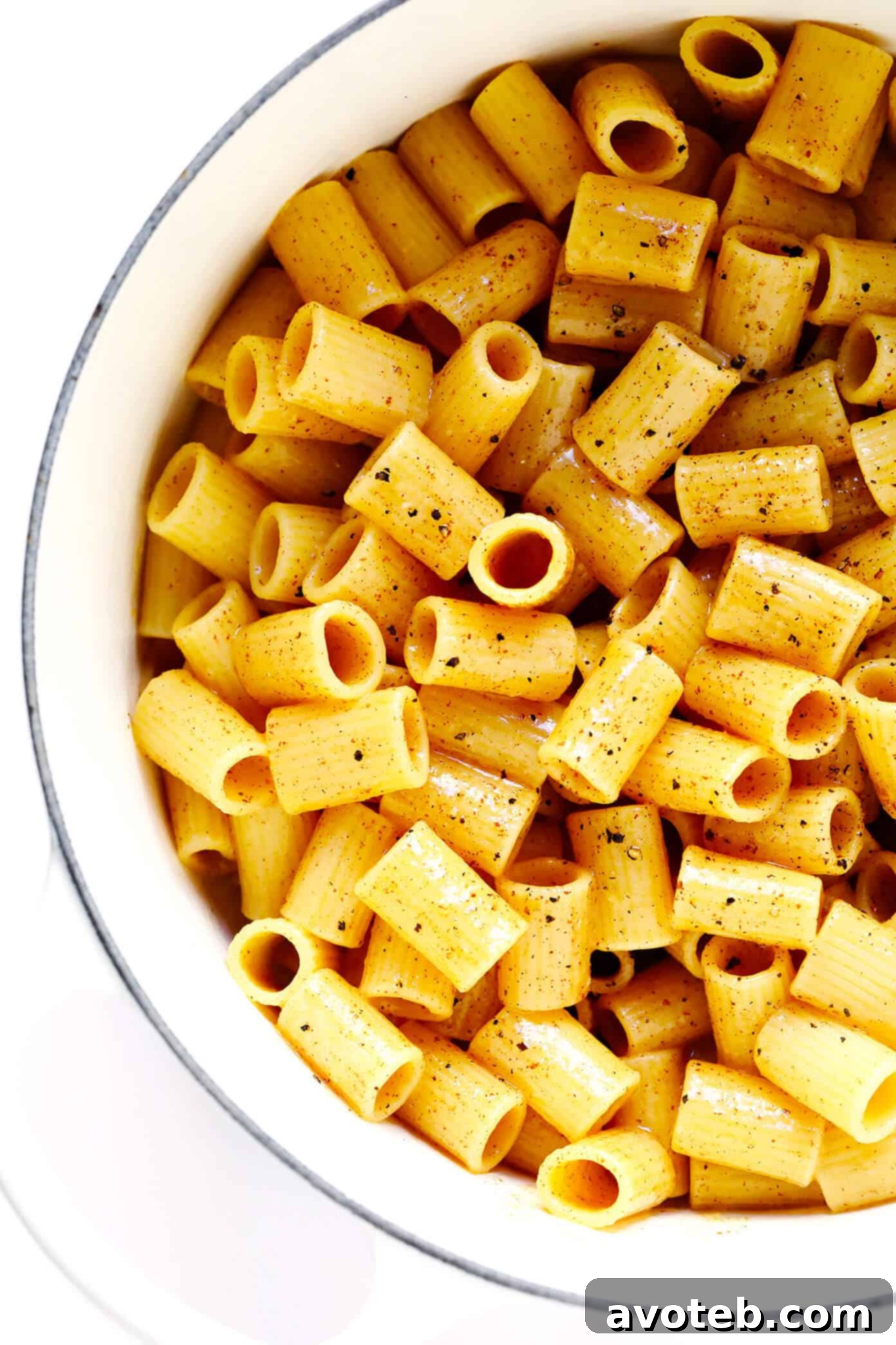 Brown Butter Lemon Pasta being tossed in a stockpot, highlighting the glossy sauce coating the pasta.