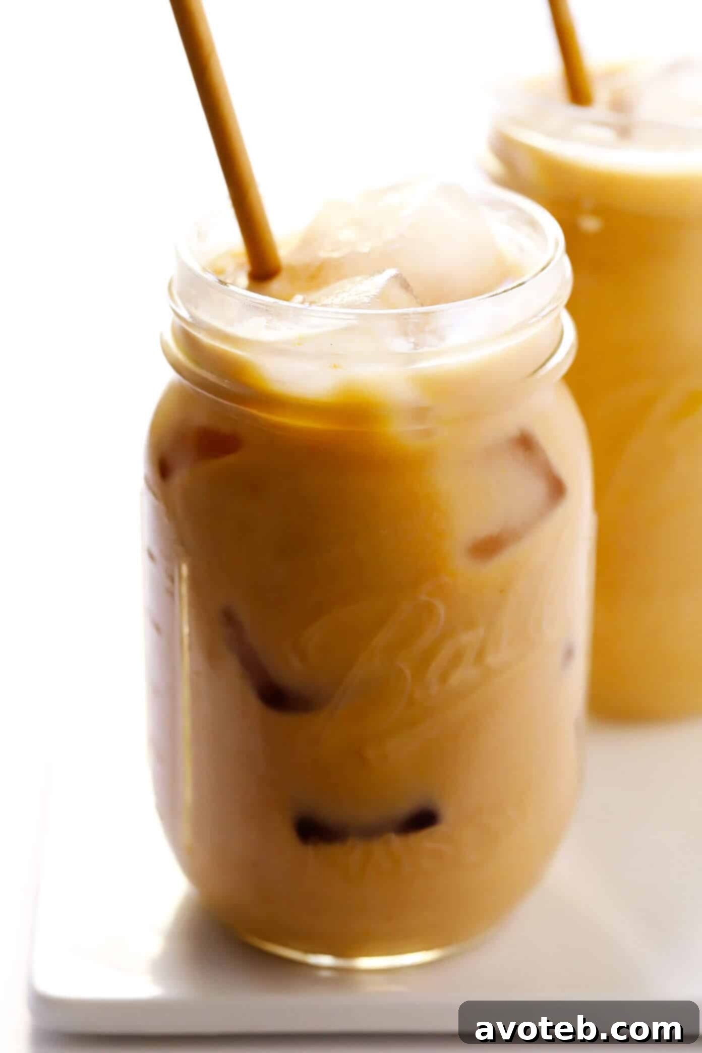 Two Iced Pumpkin Spice Lattes without Whipped Cream, showing rich color
