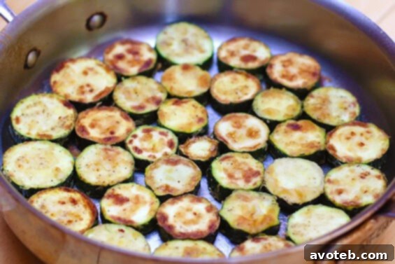 Golden brown zucchini slices ready for layering in Zucchini Parmesan