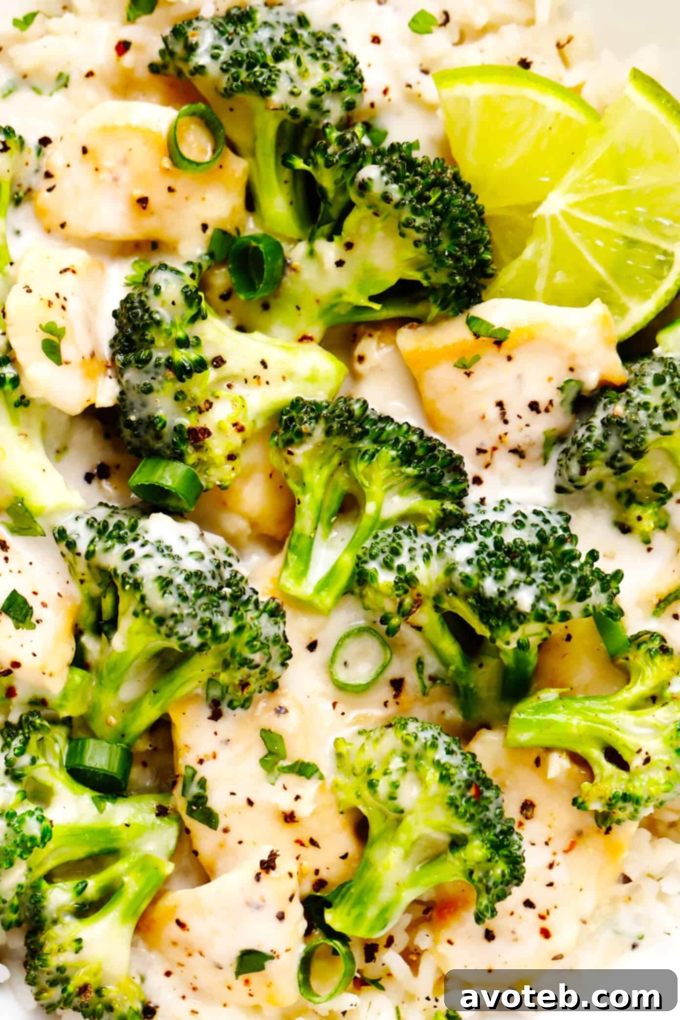 Close-up of Coconut Lime Chicken and Broccoli Stir-Fry with rice in a bowl, showing texture and garnishes