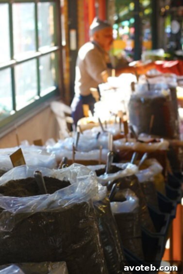 A unique spice merchant stall at The City Market, featuring an array of aromatic spices sold by the scoop.