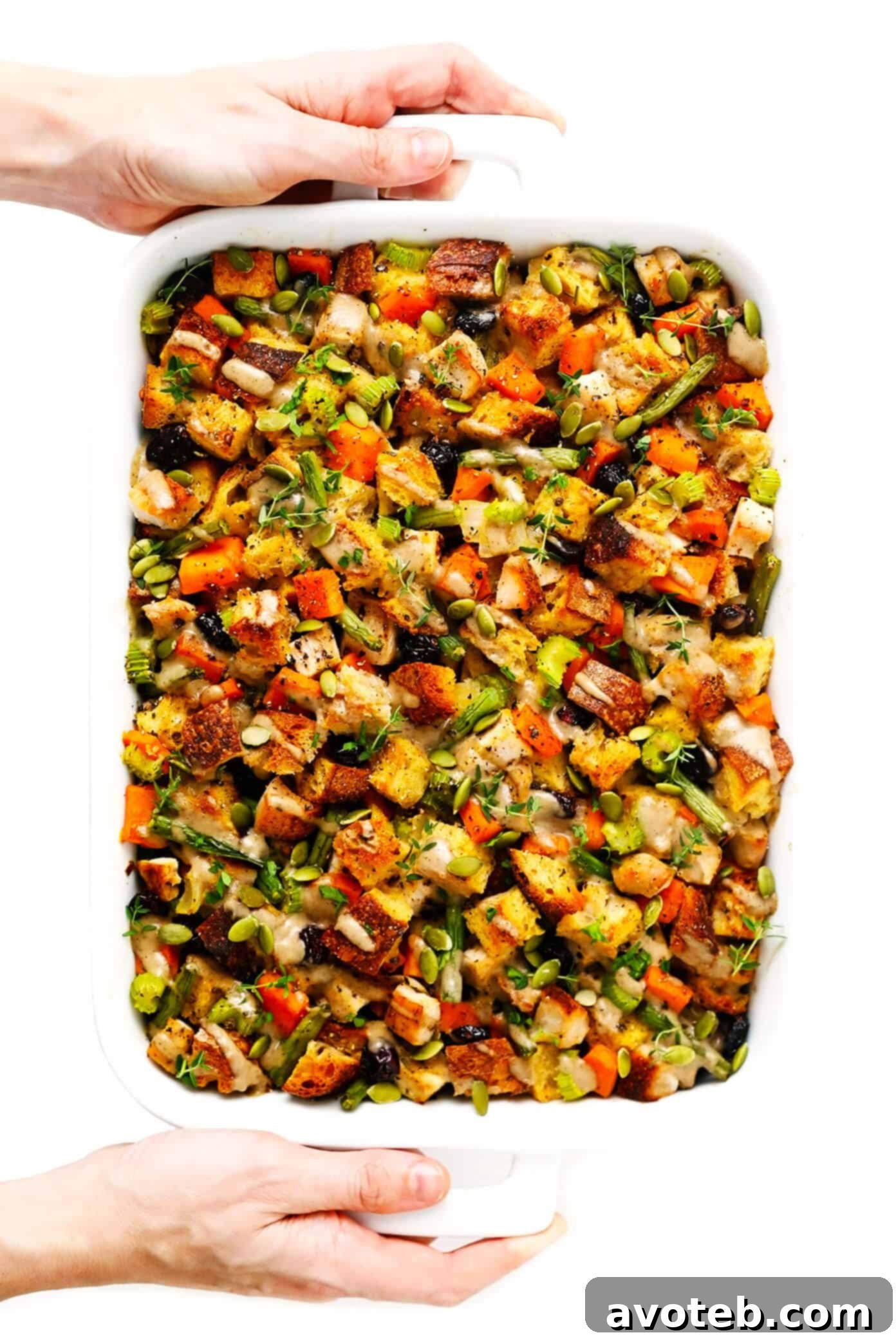 Thanksgiving Feast in One Dish 5 Holding a hot dish of Thanksgiving Casserole with turkey, sweet potatoes, and stuffing