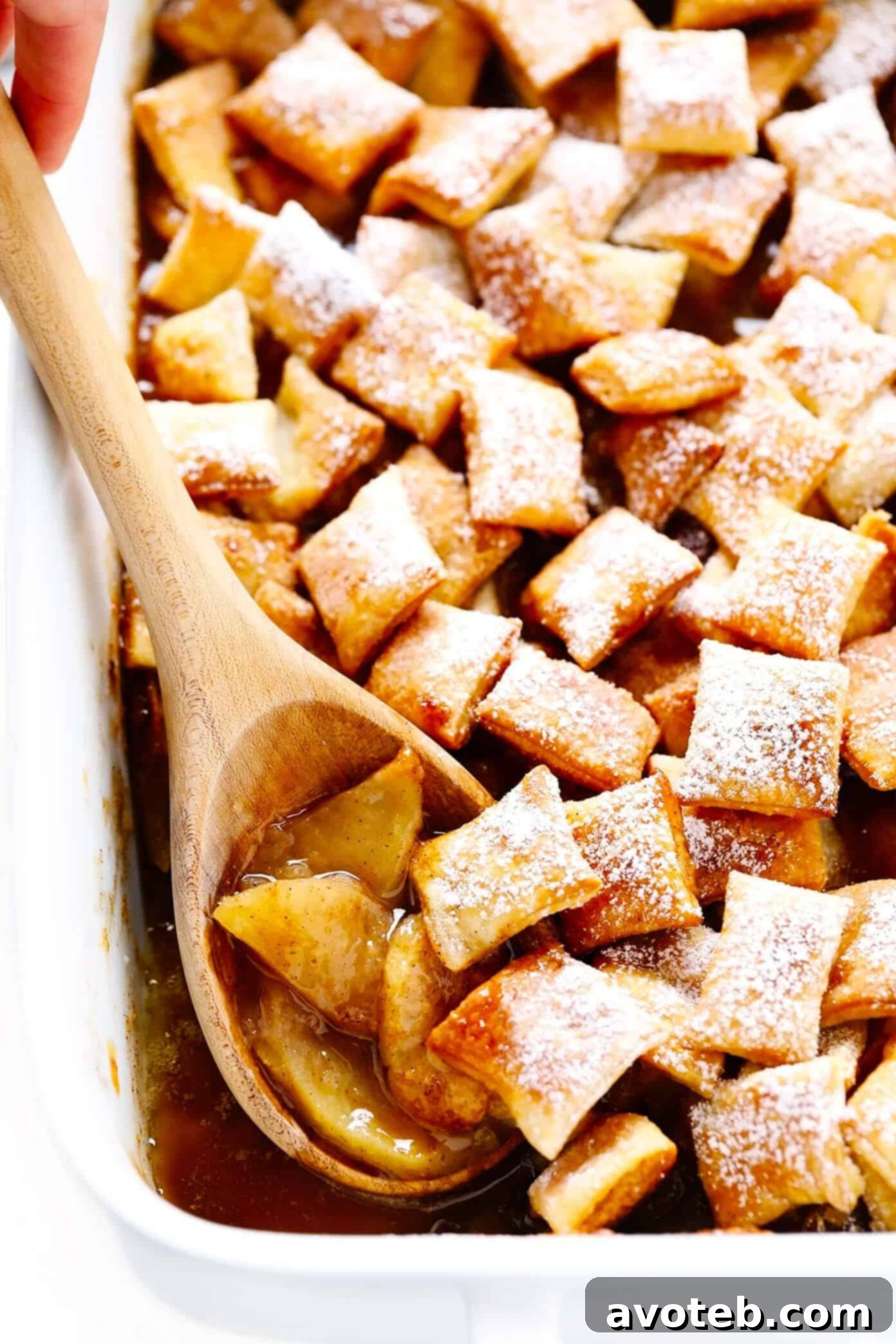 This easy Apple Pandowdy recipe is made with a delicious baked apple cinnamon pie filling topped with toasted puff pastry bites and a light dusting of powdered sugar. Absolutely delicious served warm with vanilla ice cream, and the perfect dessert for the holidays. | gimmesomeoven.com #apple #pandowdy #pie #dessert #bake #crisp #puffpastry #filling #thanksgiving #christmas Delicious Apple Pandowdy with Golden Puff Pastry Topping