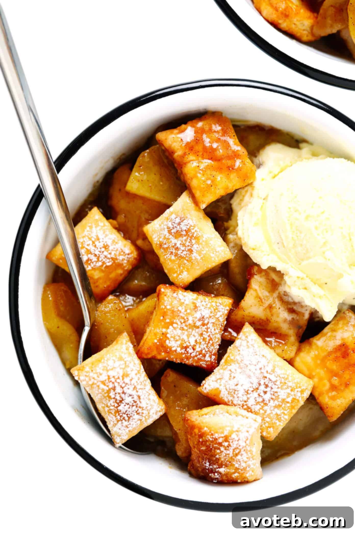 This easy Apple Pandowdy recipe is made with a delicious baked apple cinnamon pie filling topped with toasted puff pastry bites and a light dusting of powdered sugar. Absolutely delicious served warm with vanilla ice cream, and the perfect dessert for the holidays. | gimmesomeoven.com #apple #pandowdy #pie #dessert #bake #crisp #puffpastry #filling #thanksgiving #christmas Apple Pandowdy in Bowls with Vanilla Ice Cream