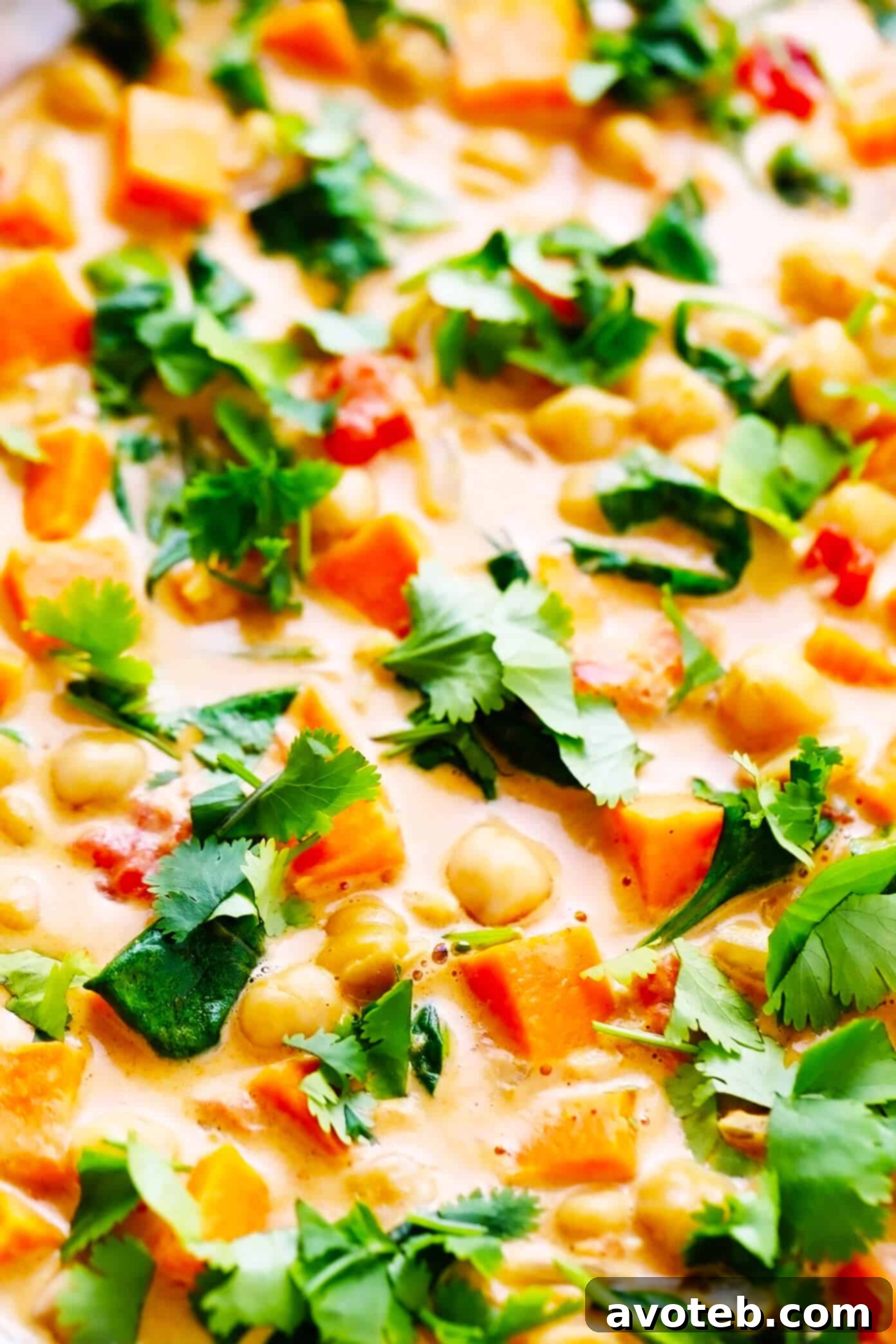 A close-up view of the rich and creamy Sweet Potato Chickpea Coconut Curry, showcasing the texture and vibrant colors of the ingredients, perfect for a cozy meal.