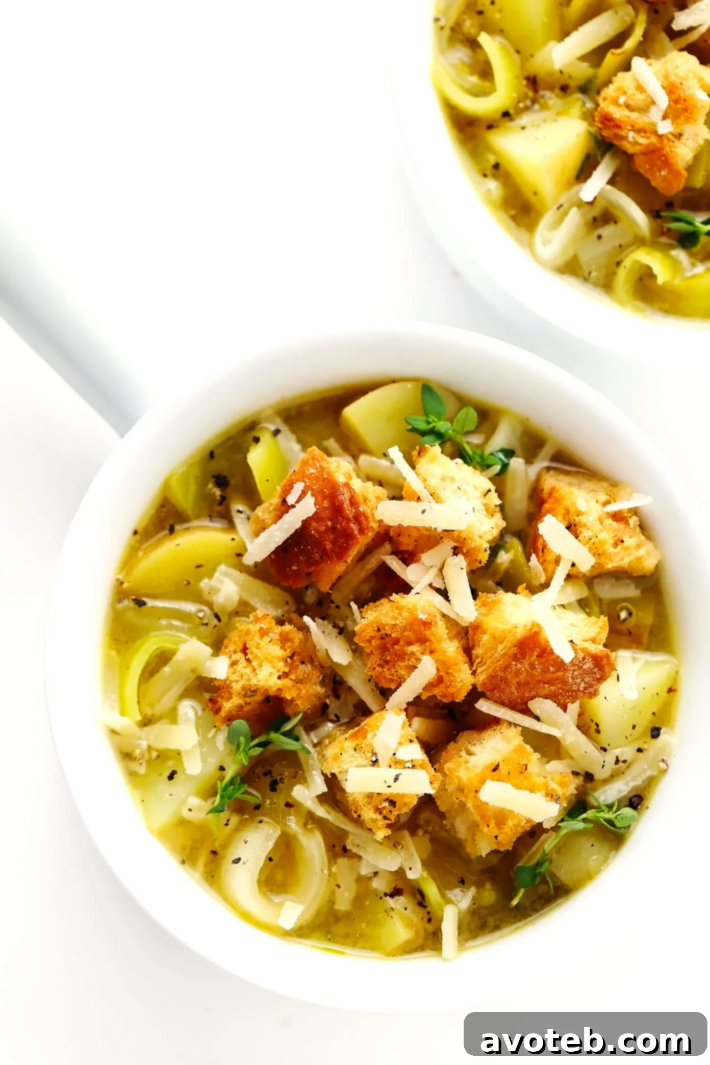 Bowls of Rustic Potato Leek Soup with Homemade Croutons and Parmesan