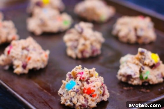 Close-up of a stack of Granola M&M Cookies, highlighting their rich texture and colorful candy pieces.
