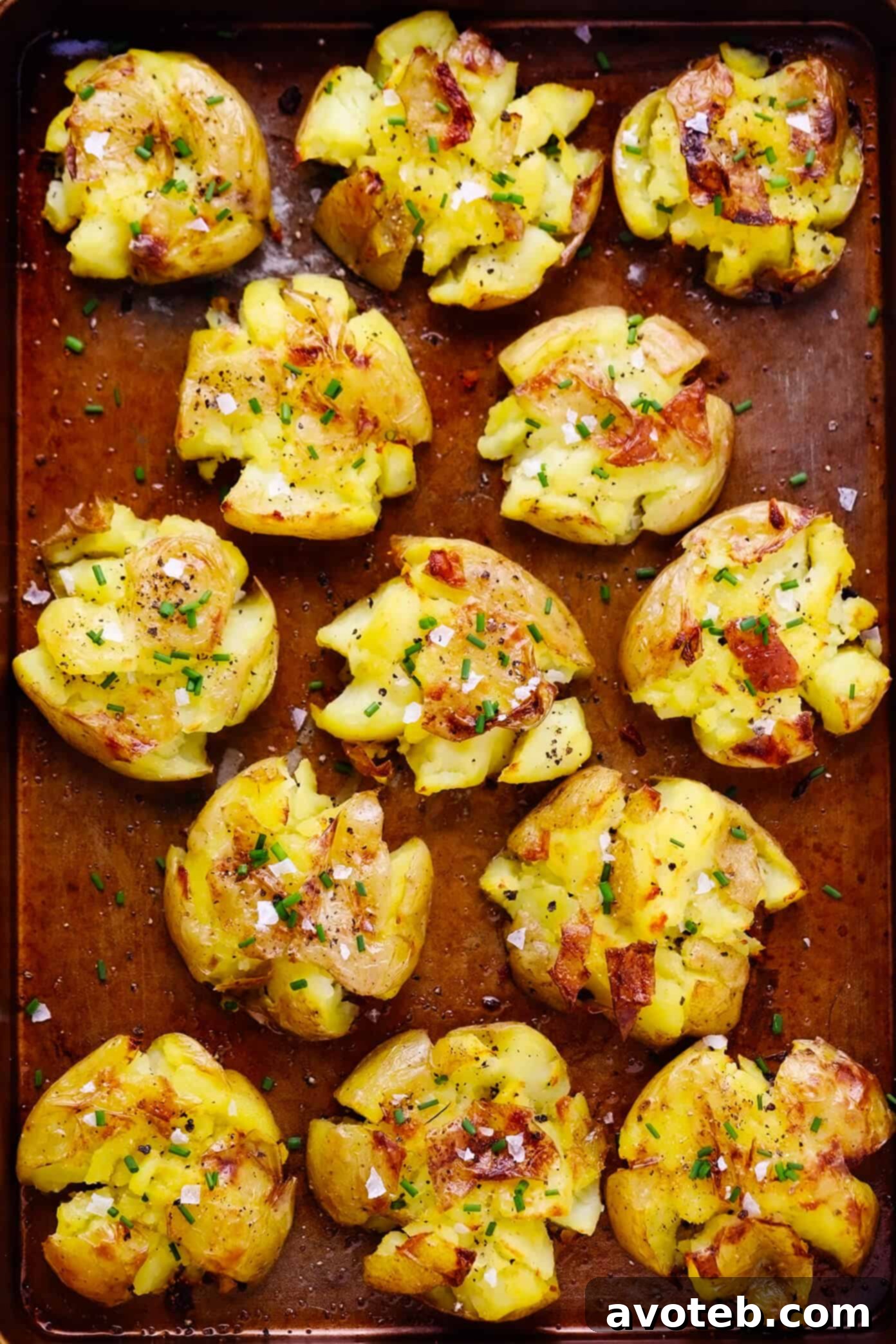 Crispy Smashed Potatoes 6 Another view of golden and crispy garlic smashed potatoes on a baking sheet, ready to be served.