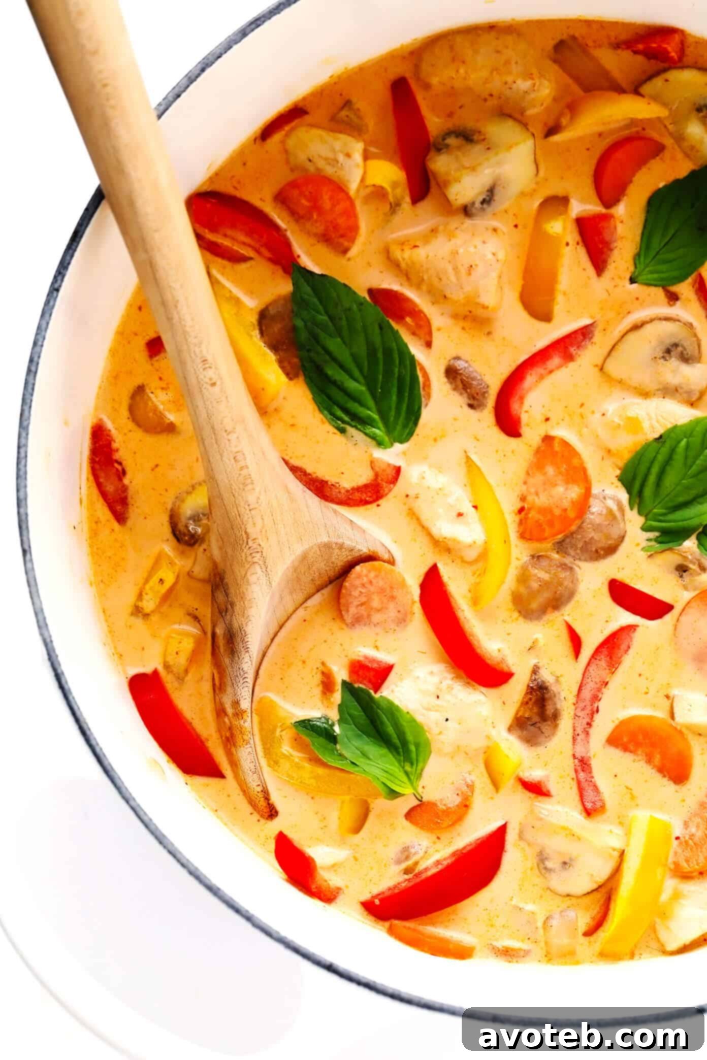 A large stockpot filled with simmering Thai Red Curry and chicken, bubbling gently on the stove.