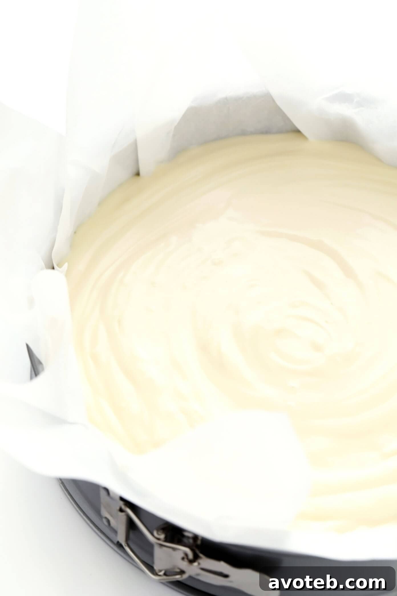 Preparing Basque Cheesecake batter in a springform pan, showing the smooth, creamy consistency before baking.