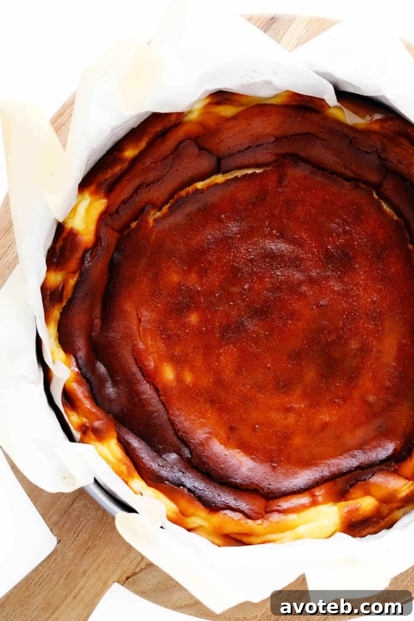 Basque Cheesecake, golden brown and perfectly 'burnt' on top, resting in a springform pan after baking.