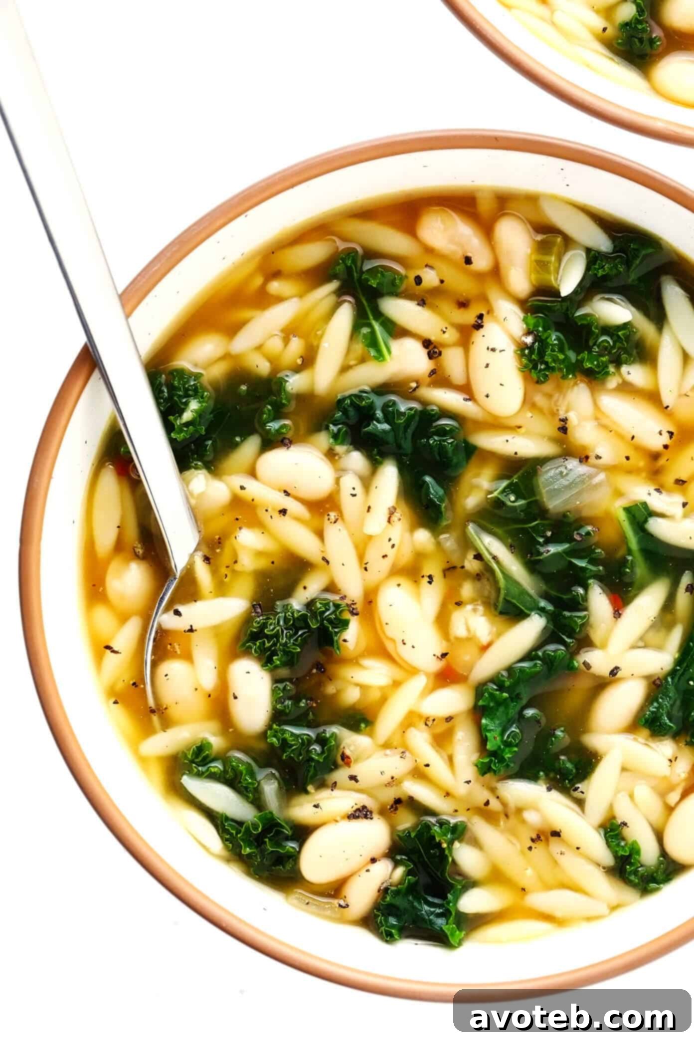 This simple Kale, White Bean and Orzo Soup is made with a cozy lemony-rosemary broth, topped with Parmesan cheese, and ready to go in just 30 minutes! A great vegetarian dinner recipe, or feel free to add a protein (chicken, bacon or sausage) if you'd like! | gimmesomeoven.com #soup #orzo #kale #bean #vegetarian #vegan #dinner #healthy Kale and Orzo Soup in Serving Bowls