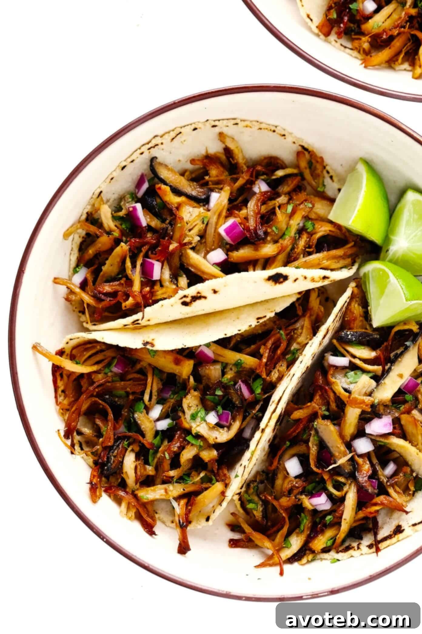 Mushroom Carnitas Tacos, garnished with fresh cilantro and lime