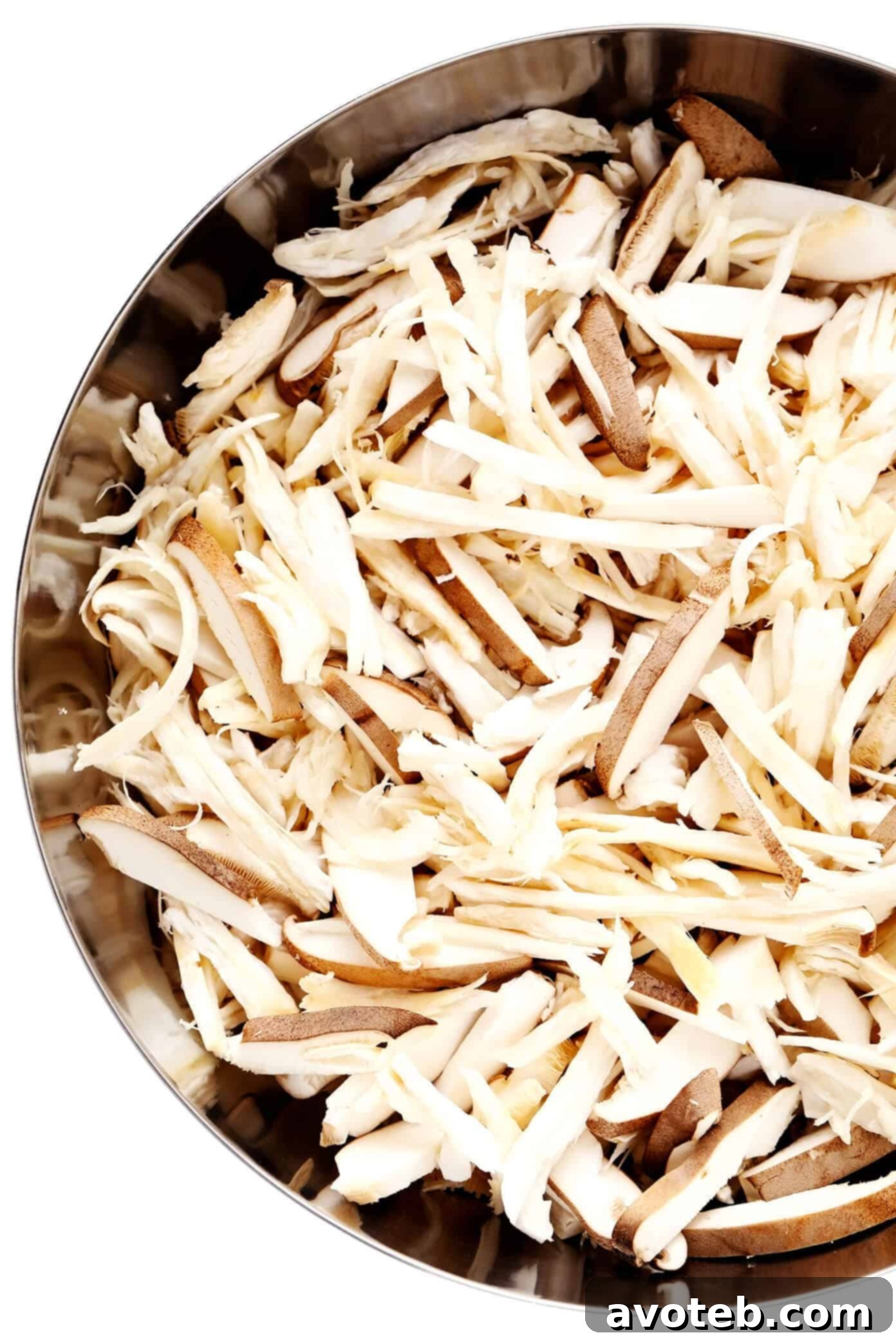 Bowl of shredded king oyster mushrooms ready for marinating