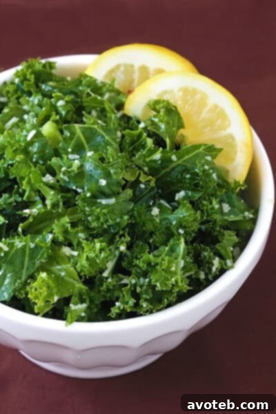 Close-up of a vibrant Lemon Parmesan Kale Salad in a rustic bowl, with a fork ready to serve.