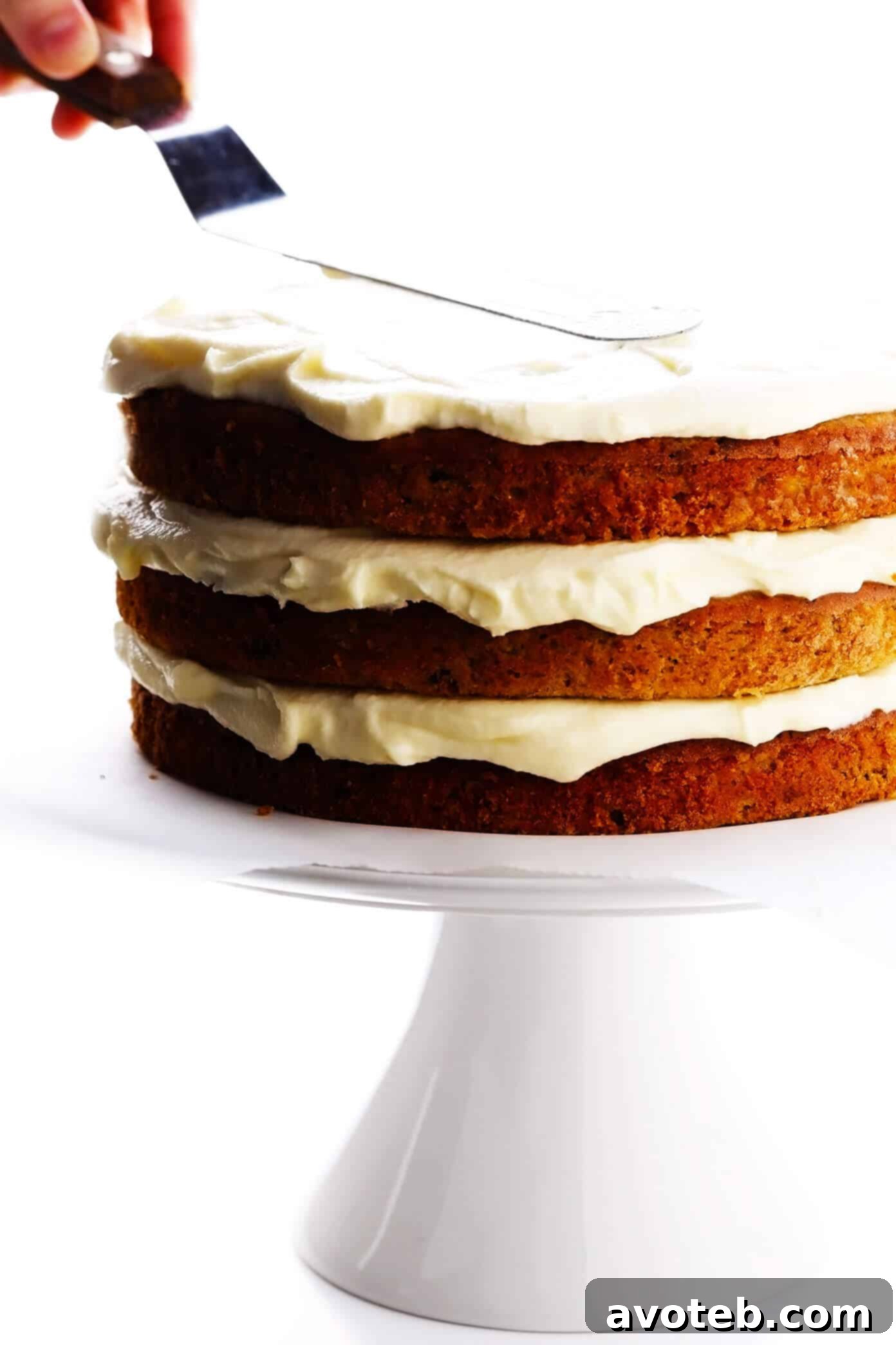 Assembling hummingbird cake layers with cream cheese frosting