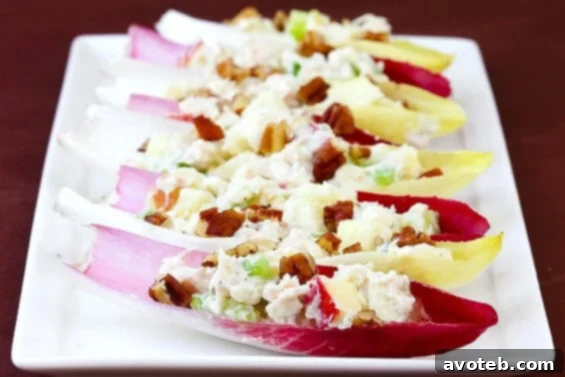 Refreshing Chicken, Apple & Gorgonzola Salad served elegantly on crisp endive spears, perfect for an autumn appetizer or light meal.