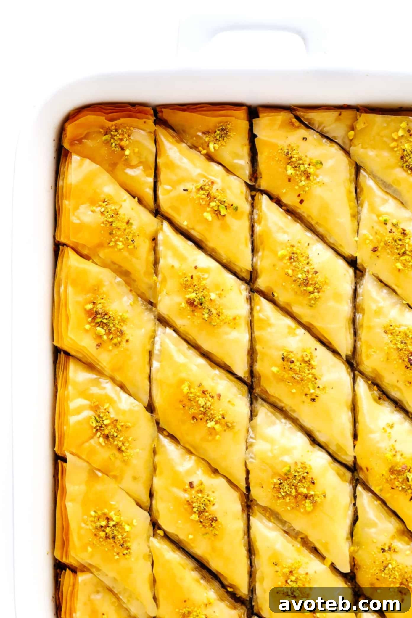 Golden, crispy layers of homemade baklava with pistachios and walnuts, drizzled with sweet citrus honey syrup, ready to be enjoyed.