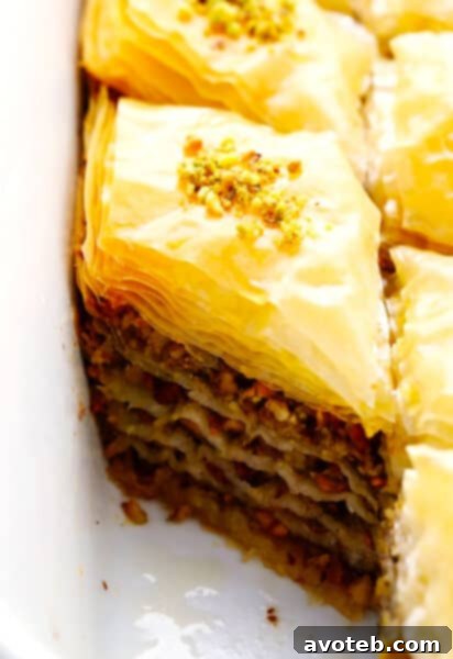 Homemade Baklava, golden brown and glistening with syrup, topped with nuts.