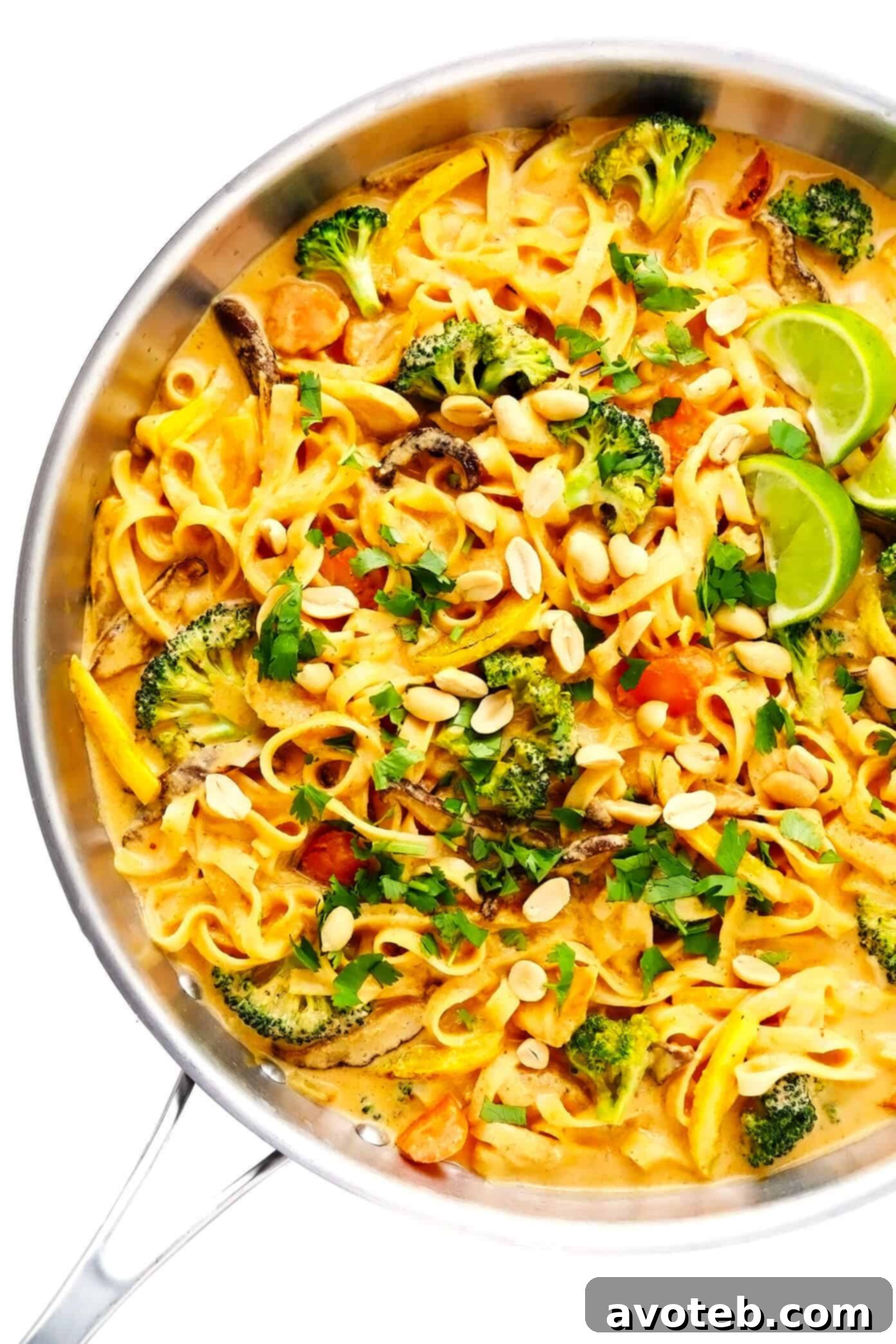 This Saucy Thai Curried Peanut Noodles is made with the yummiest creamy coconut curry peanut sauce and your choice of noodles, veggies and protein. A great 35-minute easy dinner recipe that's naturally gluten-free and easy to make vegetarian or vegan, if you'd like! | gimmesomeoven.com #curry #noodles #peanut #vegetable #chicken #healthy #stirfry #thai #sauce #dinner #pasta Thai Coconut Curry Peanut Noodles cooking in a large sauté pan, coated in rich sauce.