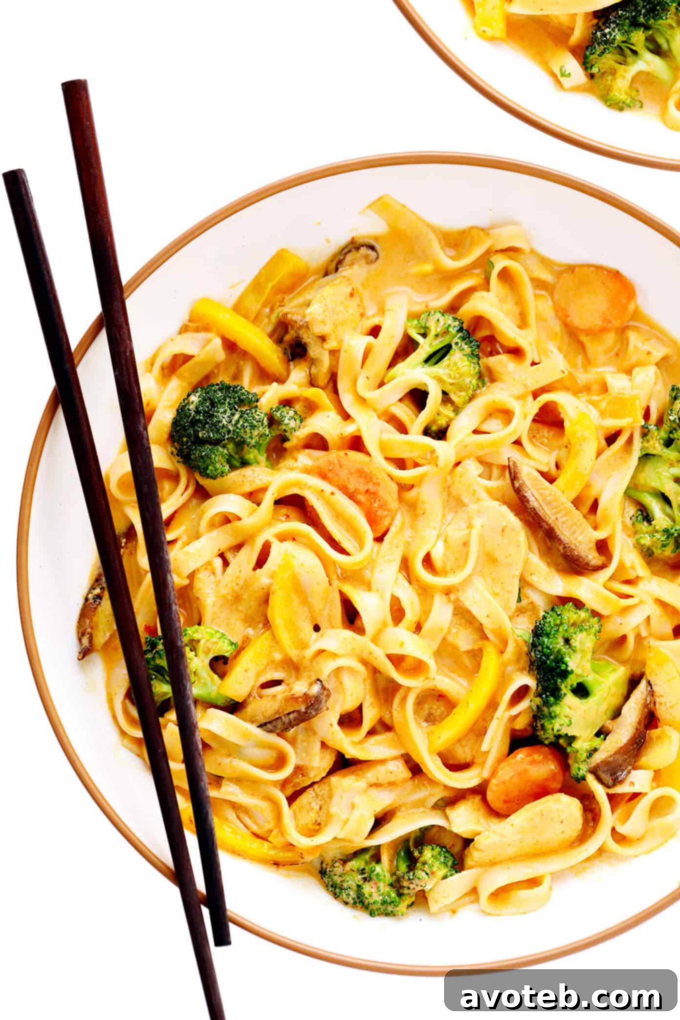 This Saucy Thai Curried Peanut Noodles is made with the yummiest creamy coconut curry peanut sauce and your choice of noodles, veggies and protein. A great 35-minute easy dinner recipe that's naturally gluten-free and easy to make vegetarian or vegan, if you'd like! | gimmesomeoven.com #curry #noodles #peanut #vegetable #chicken #healthy #stirfry #thai #sauce #dinner #pasta Saucy Thai Curried Peanut Noodles served in a bowl with thinly sliced chicken, garnished with fresh cilantro and lime.