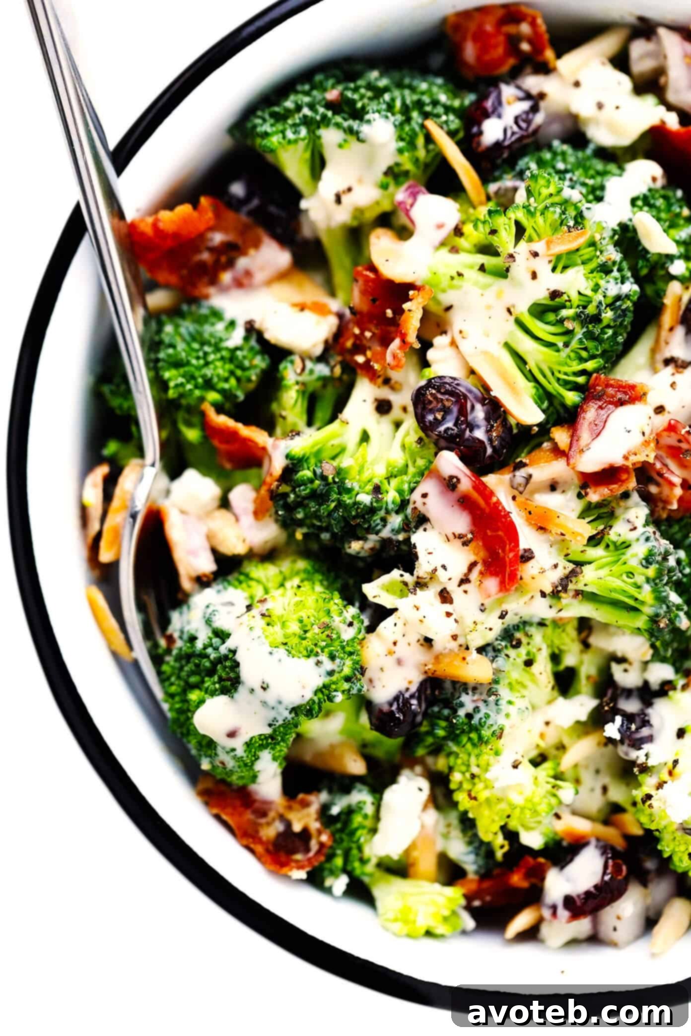 Broccoli Salad with crispy bacon, cranberries, and almonds in a serving bowl