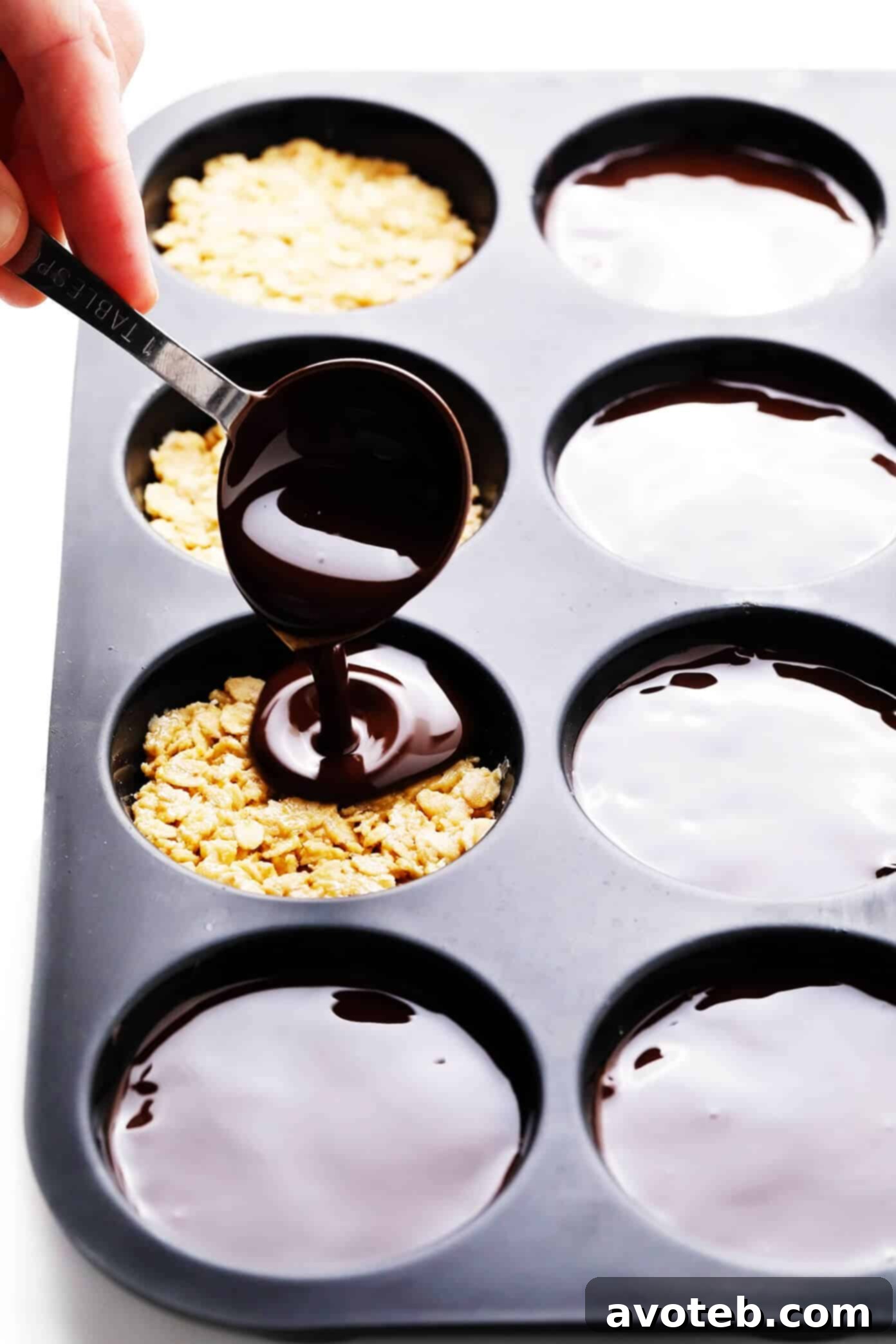Drizzling melted chocolate over peanut butter oat cups