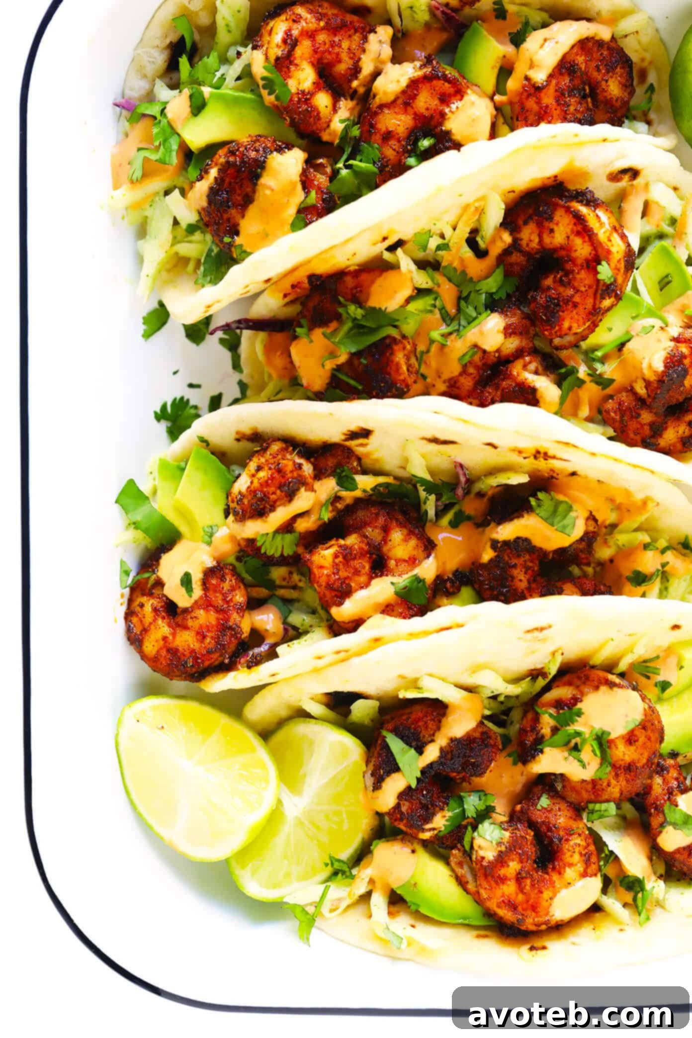 The BEST Shrimp Tacos recipe! Made with zesty shrimp, cilantro lime coleslaw, sliced avocado and spicy chipotle crema. Kick them up a notch with homemade flour tortillas too, if you'd like!