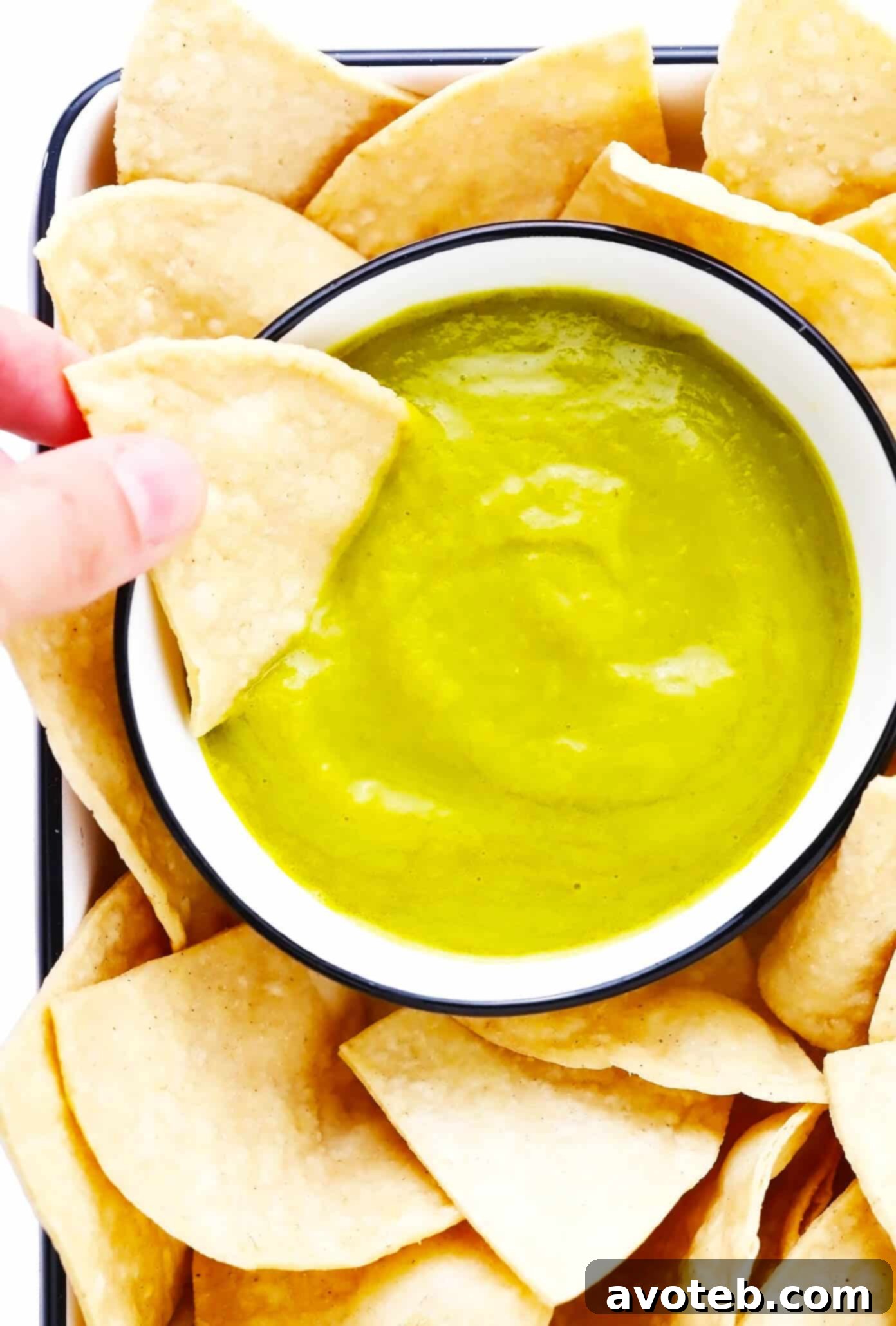 This 5-ingredient creamy jalapeño salsa recipe is easy to make in 30 minutes and irresistibly garlicky and flavorful. Perfect for dipping with chips or drizzling on whatever other Mexican-inspired dishes you love best. It is naturally gluten-free and vegan, and options are included to make this salsa as mild or spicy as you prefer. | gimmesomeoven.com Creamy Jalapeño Salsa with Tortilla Chips, perfect for dipping or drizzling