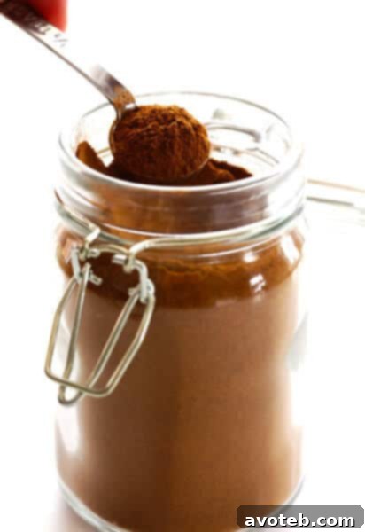 Homemade Pumpkin Pie Spice blend in a small jar, garnished with whole cinnamon sticks and star anise.