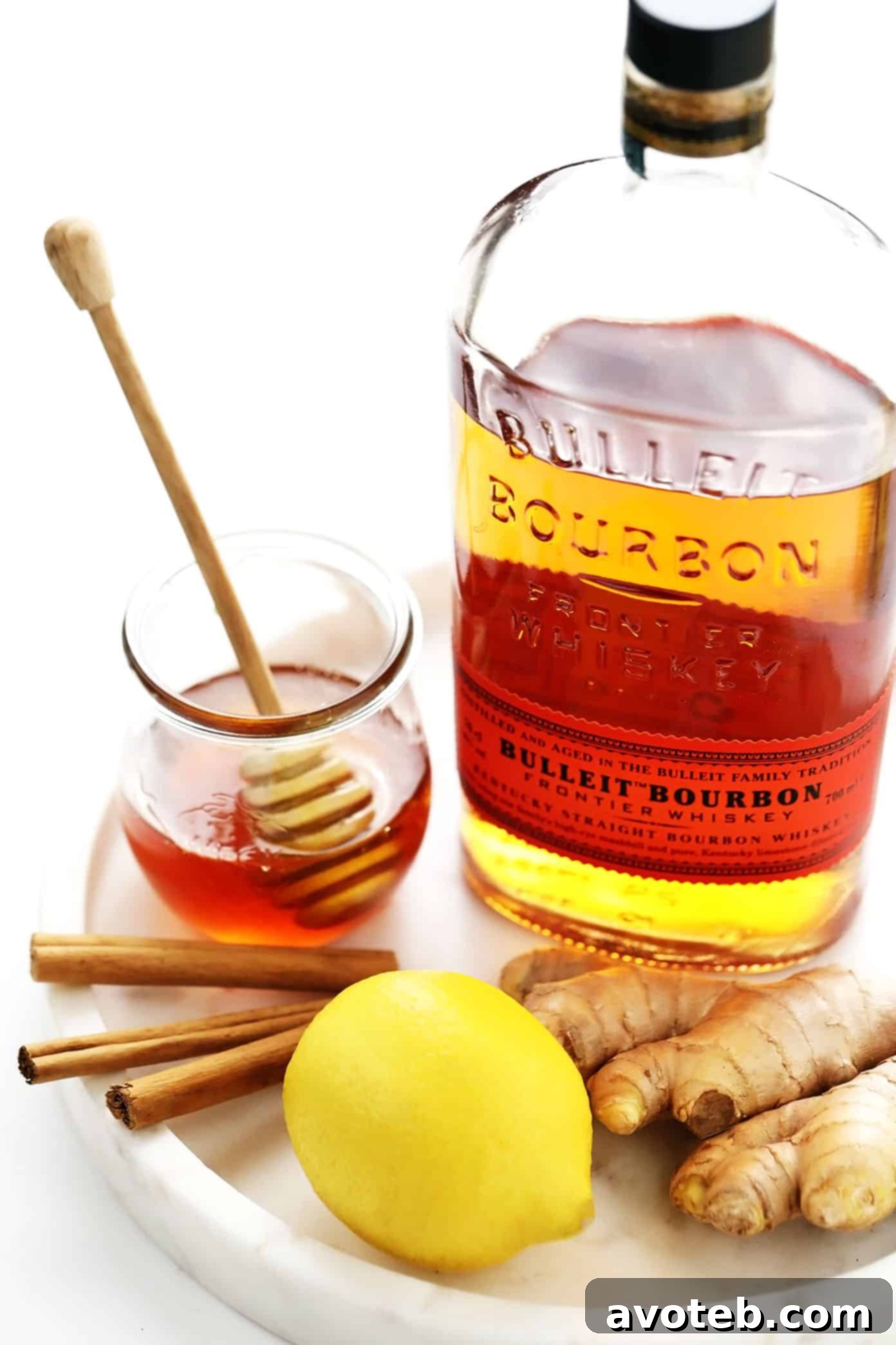 Hot Toddy Ingredients: Bourbon, Honey, Lemon, Cinnamon Sticks, and Fresh Ginger