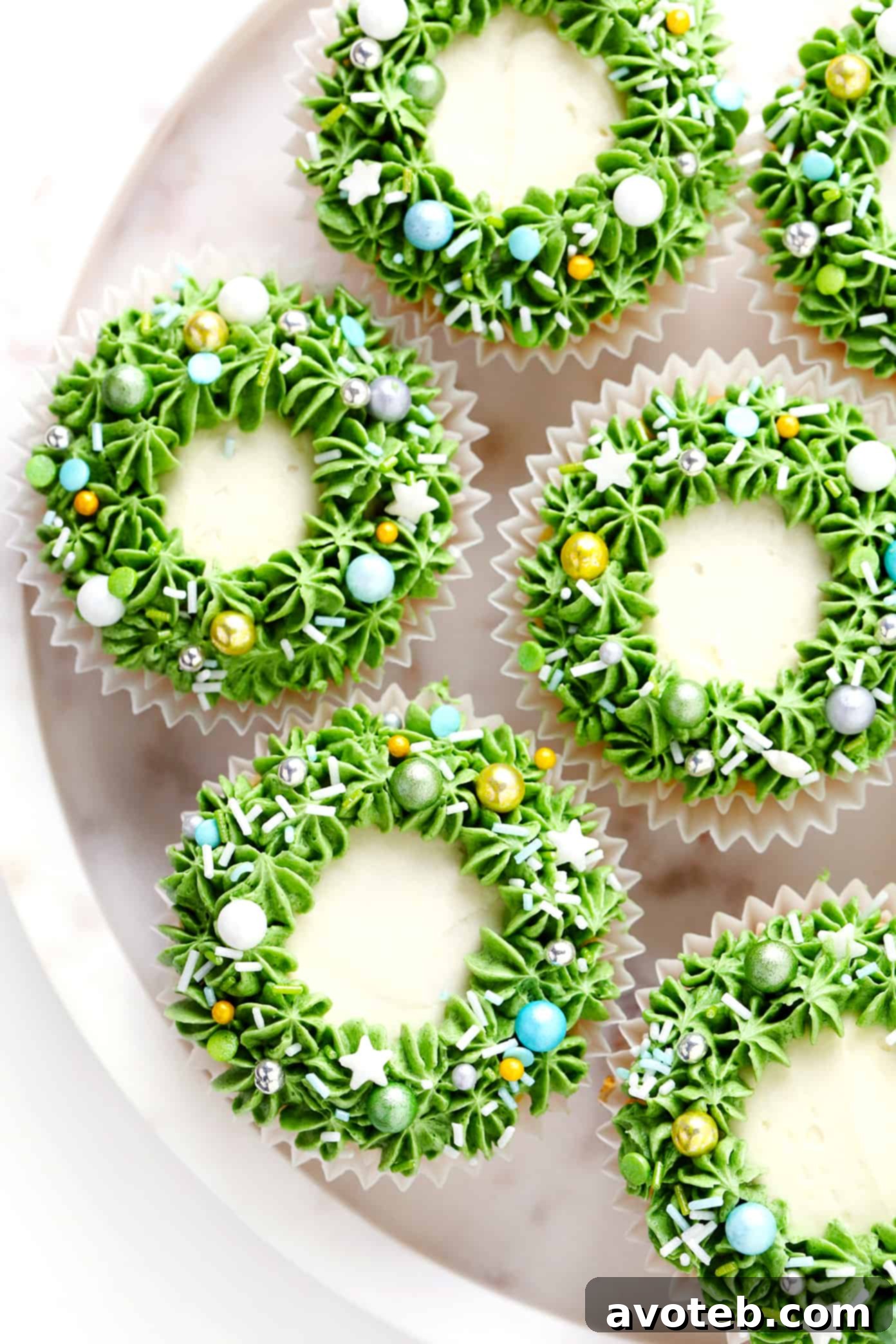 Christmas Wreath Cupcakes on a plate with red and green sprinkles