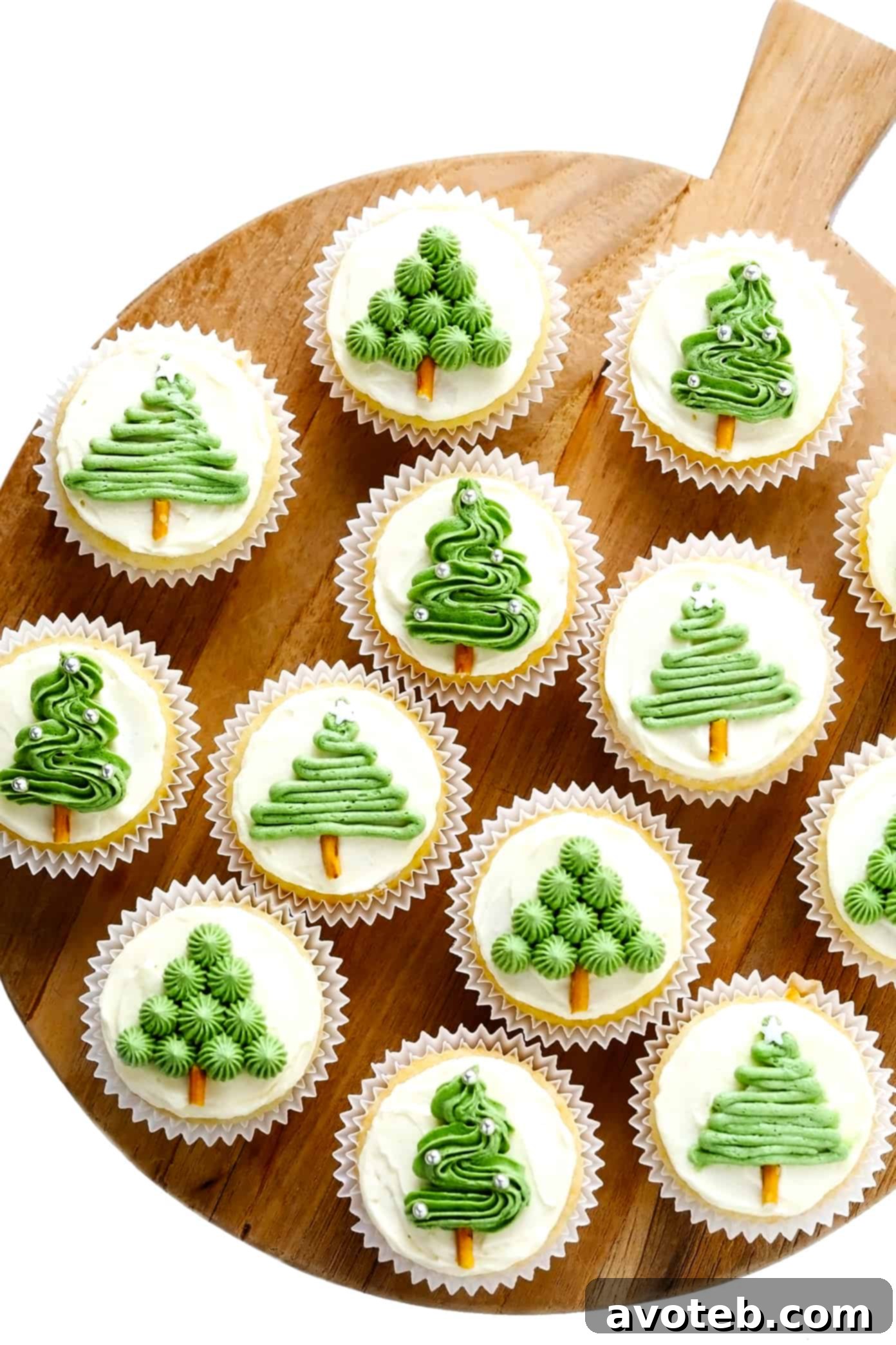 Christmas Tree Cupcakes displayed on a rustic wooden tray