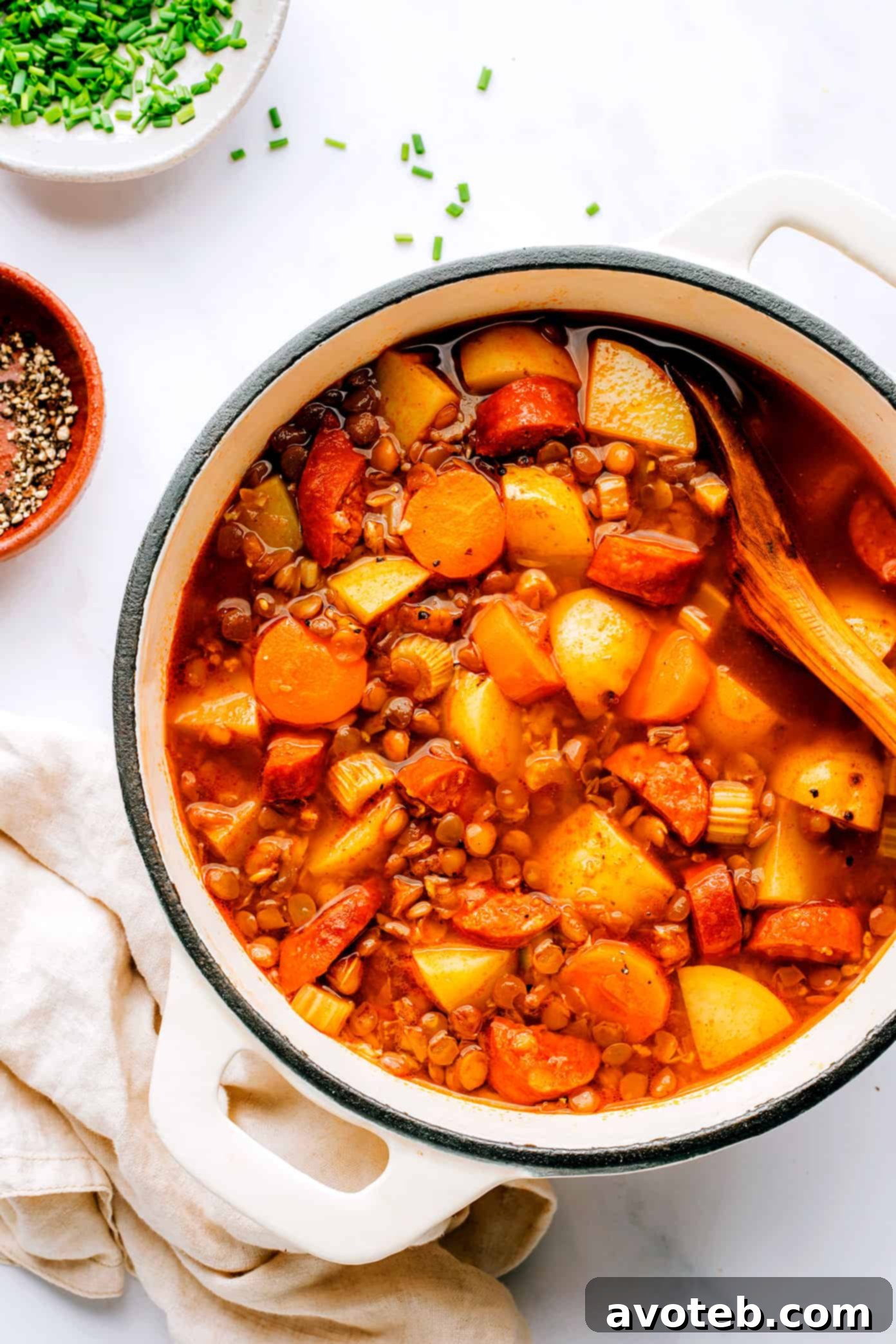 Stockpot filled with simmering Spanish Chorizo Lentil Soup.