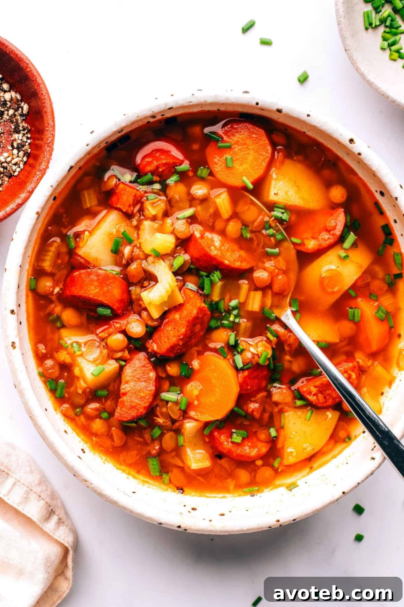 Close-up of a bowl of Spanish Chorizo Lentil Stew, with steam rising, inviting to eat.