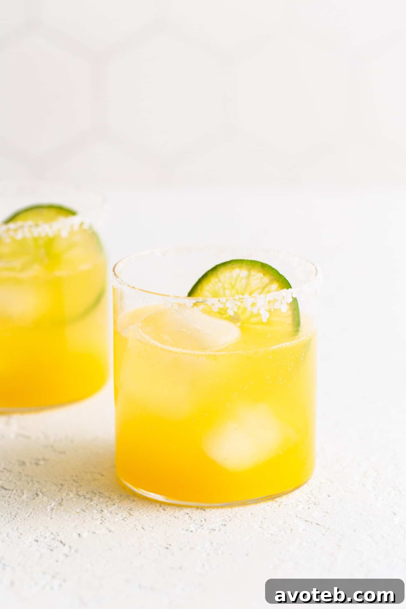 This virgin margarita mocktail recipe is quick and easy to make without alcohol, yet it's still so tangy, refreshing and delicious. Perfect to serve with your favorite Mexican food...or anytime you're craving a great mocktail! Virgin Margaritas in Glasses with Lime