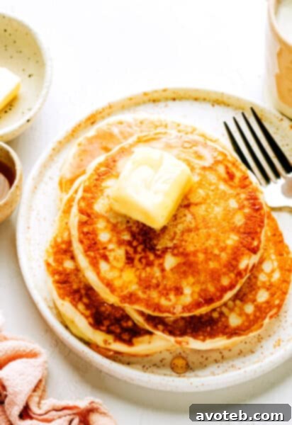 A stack of golden kefir pancakes on a plate, ready for a delicious breakfast.