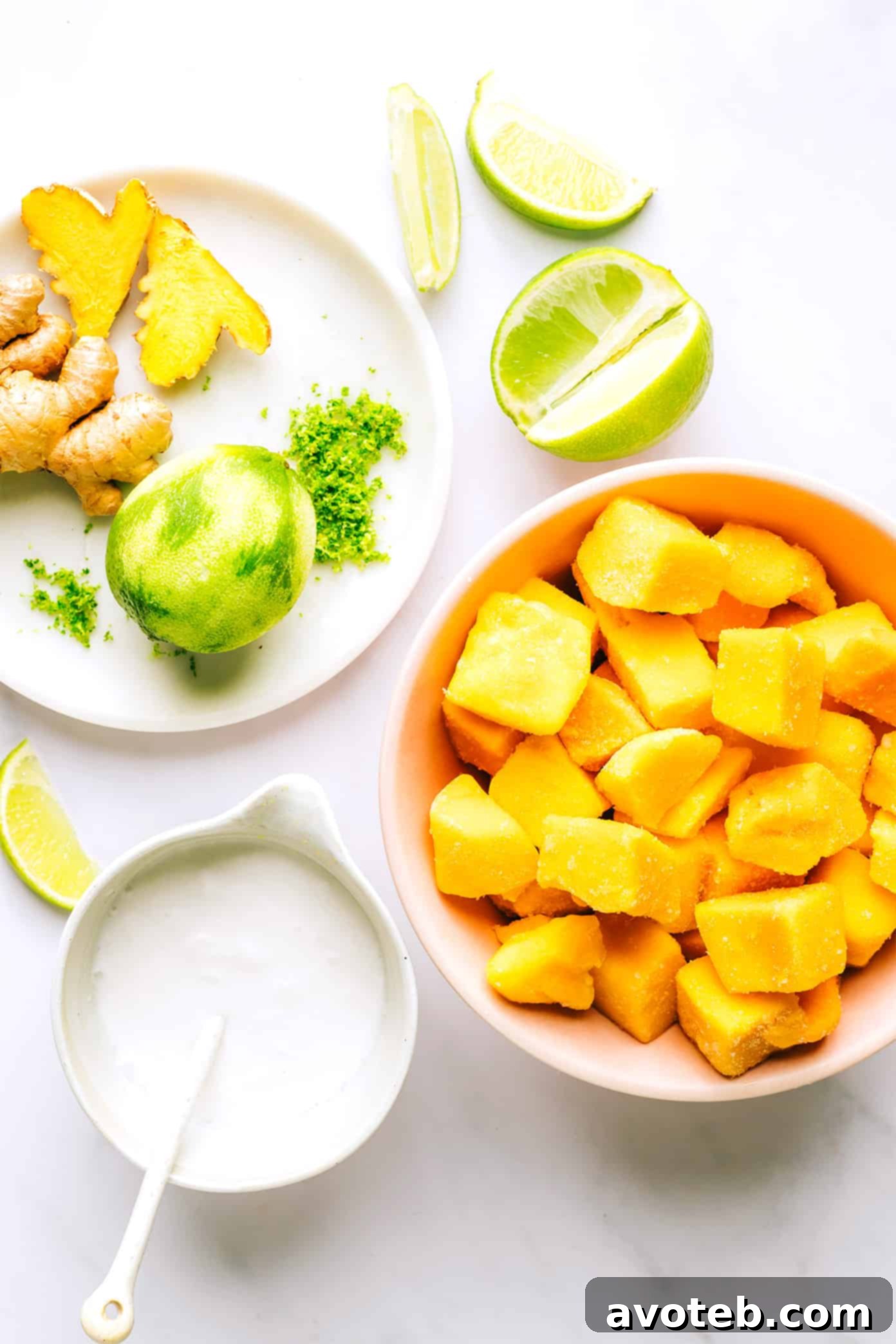 Mango Lime Sorbet Ingredients - Close up of frozen mango, fresh ginger, coconut milk, and lime.